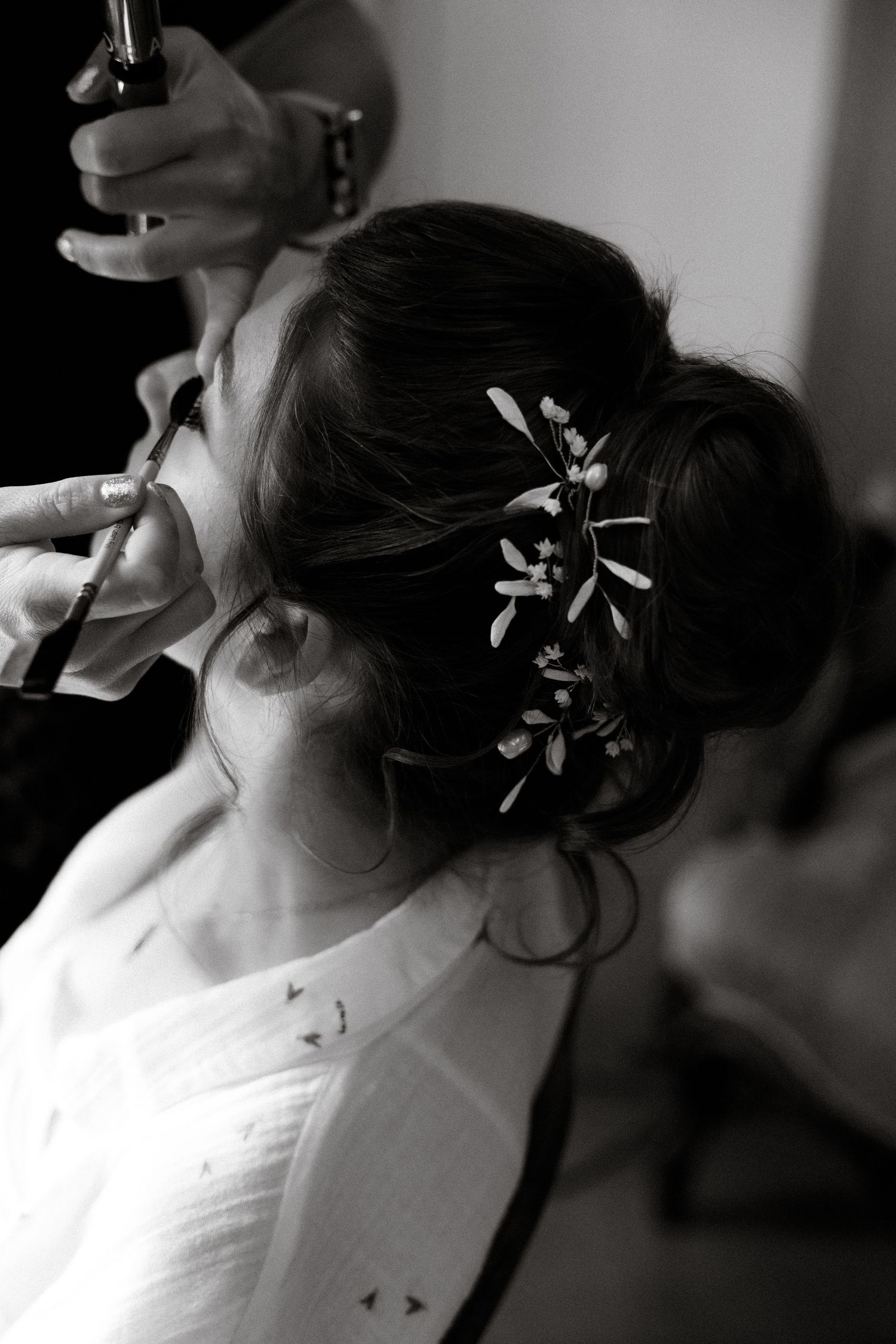 Elegant bridal hairstyle with decorative hair accessories captured in black and white.