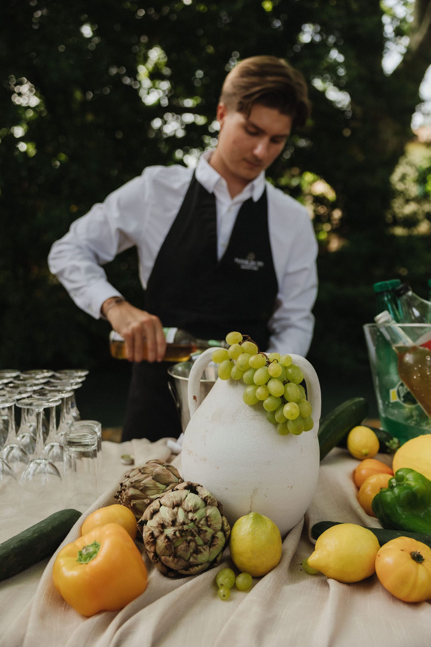 Wedding catering setup with fresh fruits and citrus displayed on rustic table.