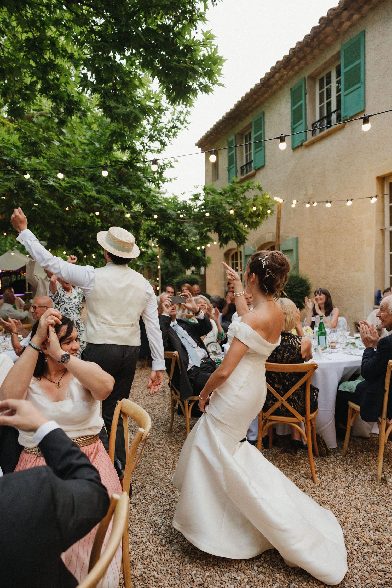 A sequence of dance moves at a wedding reception shows guests swaying and dipping on a patio.