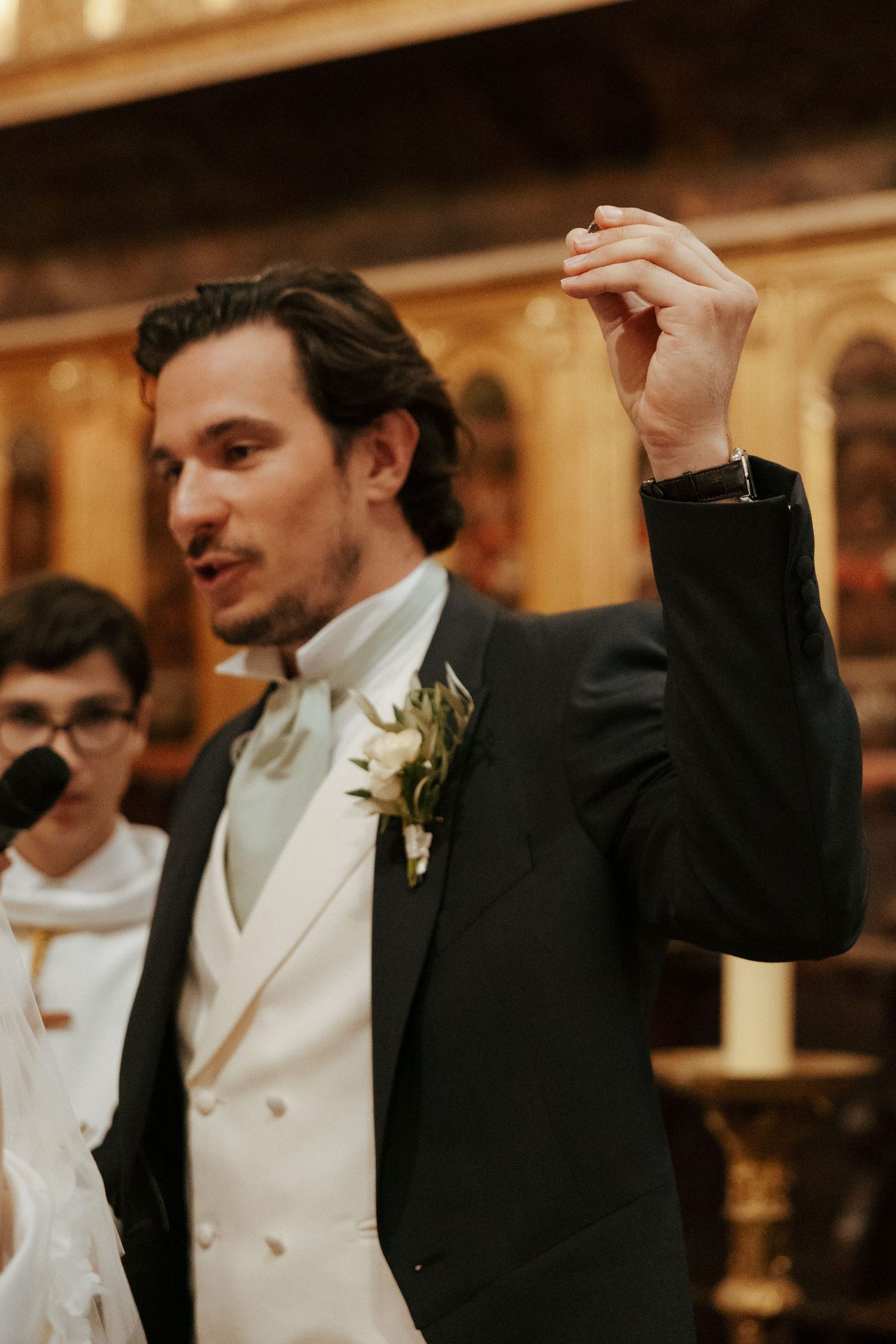 Celebratory sequence showing formal attire and raised hands at an elegant indoor event.