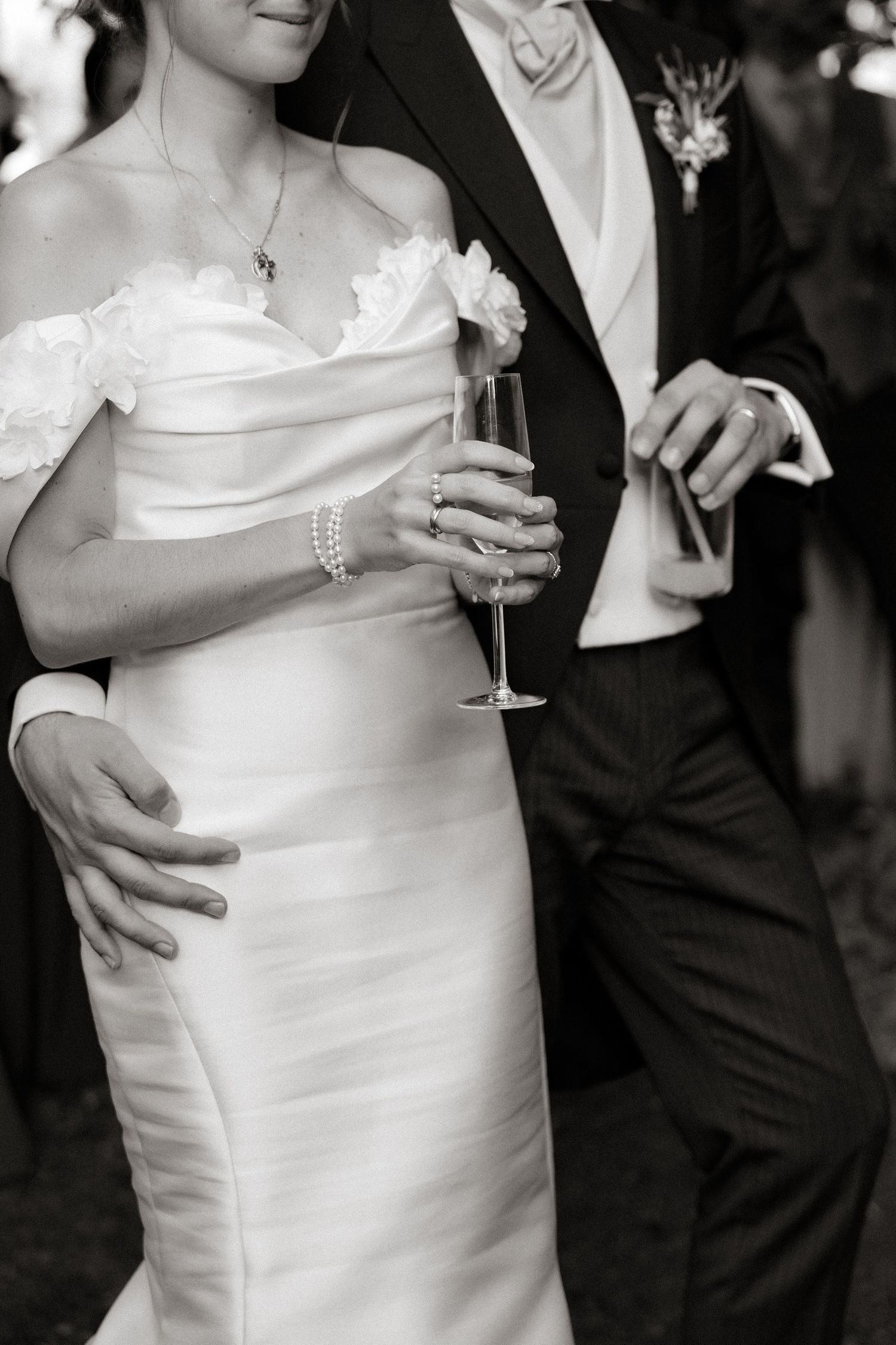 Elegant couple in black and white formal attire dancing together at a wedding reception.
