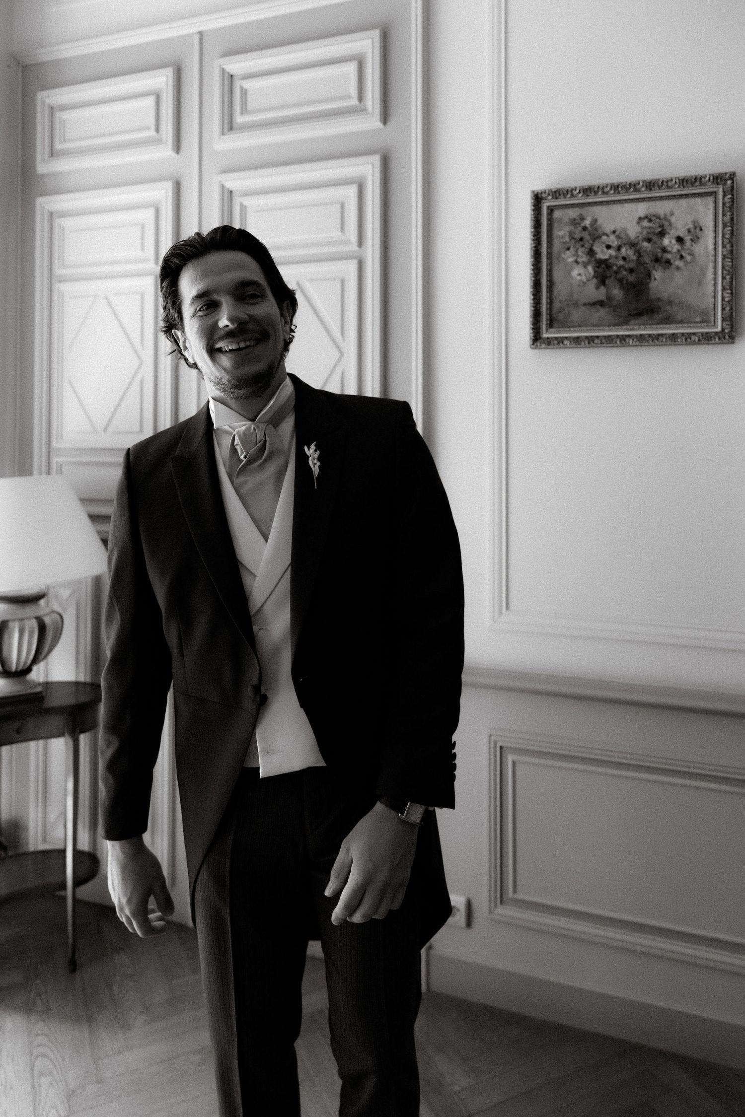 A series of black and white photos showing formal wedding attire preparations.