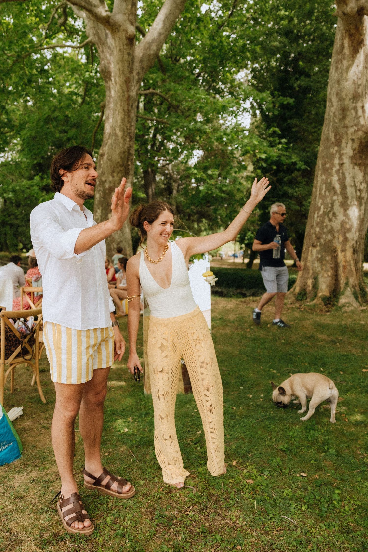 A sequence of four photos showing people playing with pants hanging on a clothesline outdoors in a park setting.