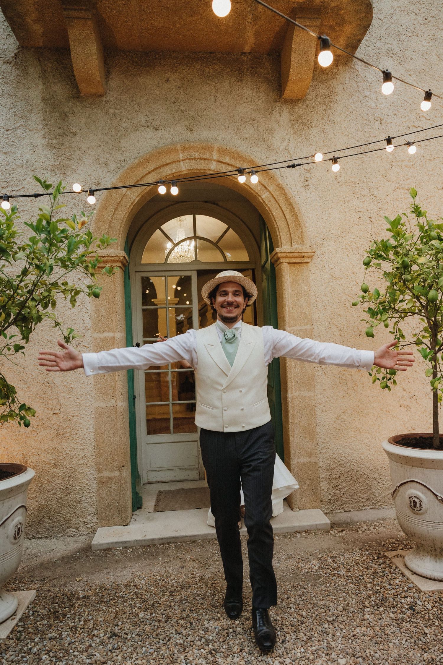 Wedding venue courtyard with string lights and arched windows creates romantic ambiance.