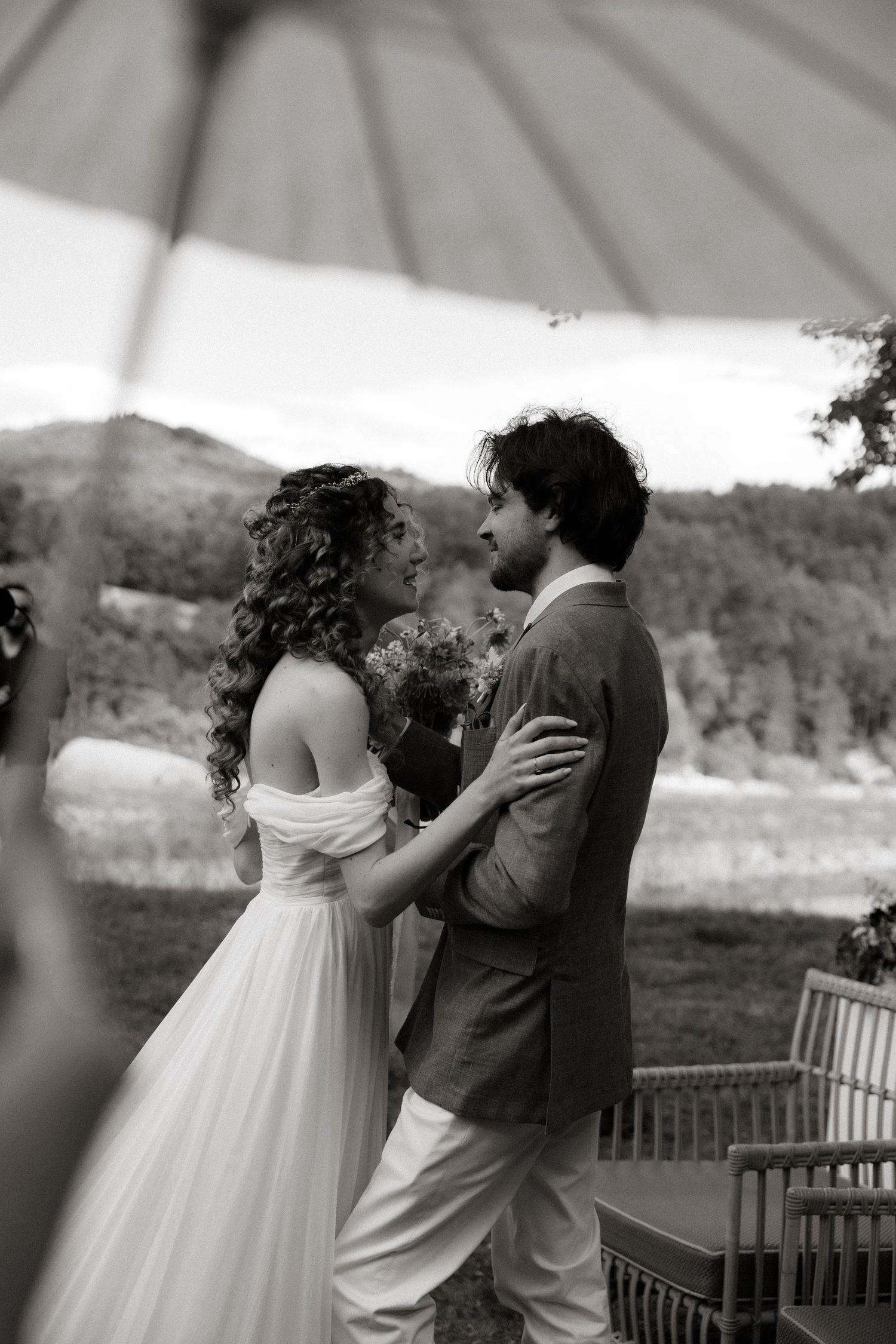 Black and white sequence of a romantic couple dancing together on a terrace overlooking scenic mountains and lake.