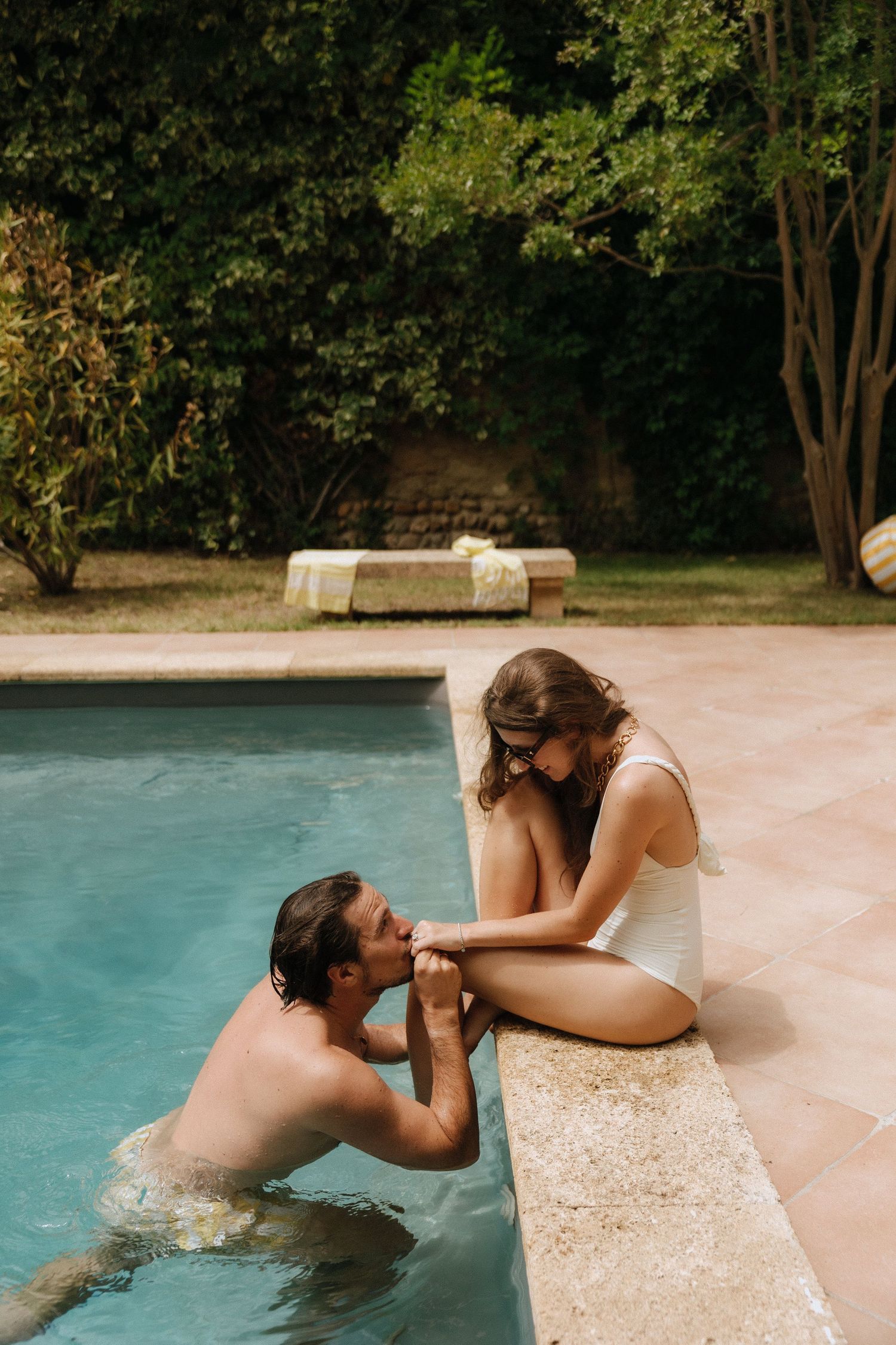 Romantic poolside moment captured during a summer wedding celebration.