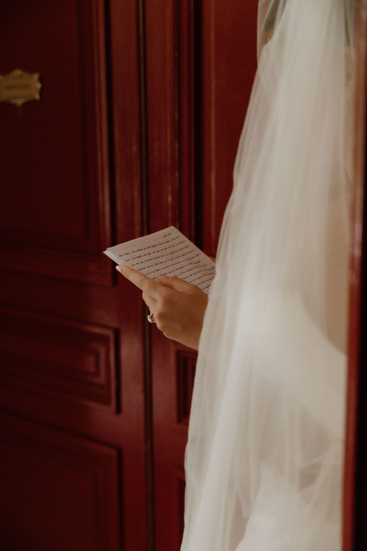 Close-up shots of a wedding veil and dress details against rich wooden paneling.