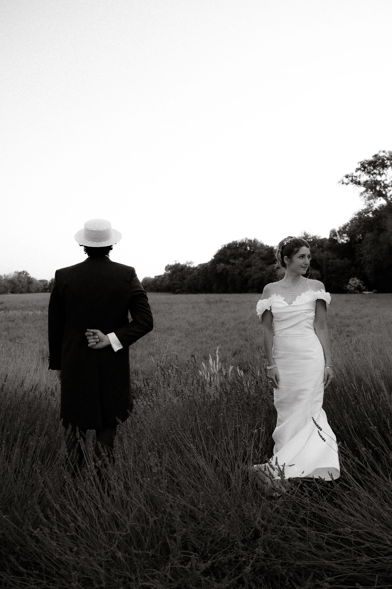 Black and white artistic wedding photos of a couple sitting in a lavender field.