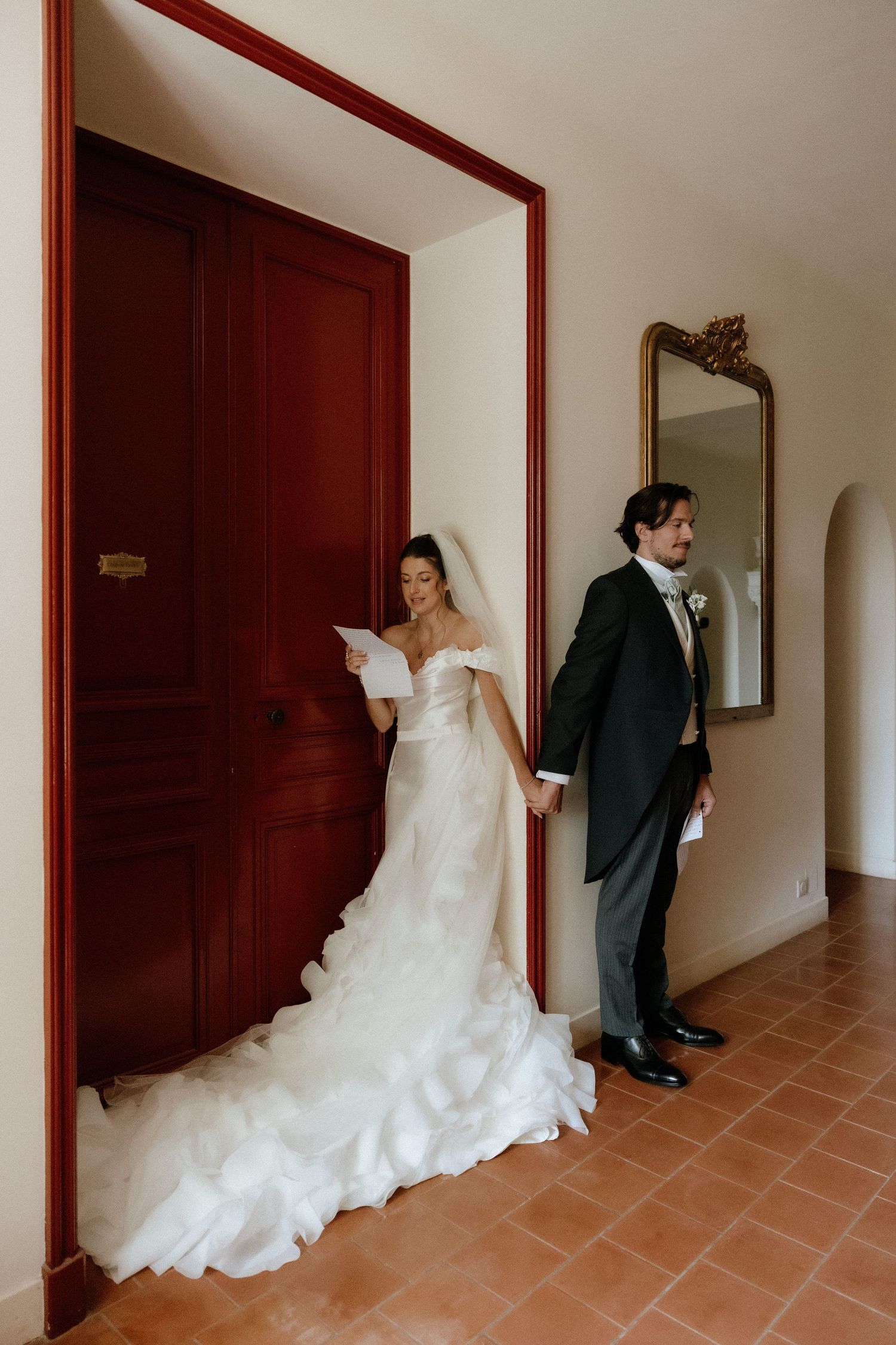 Sequential photos of a bride and groom's first look moment in a hallway with terracotta floors.