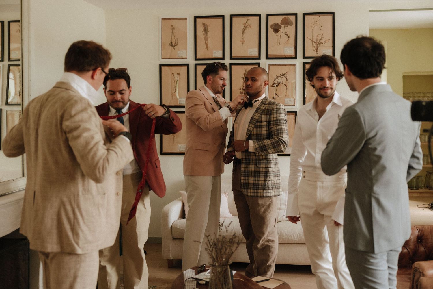 A photo progression of formal-dressed people enjoying wine and dancing at a celebration in warm lighting.