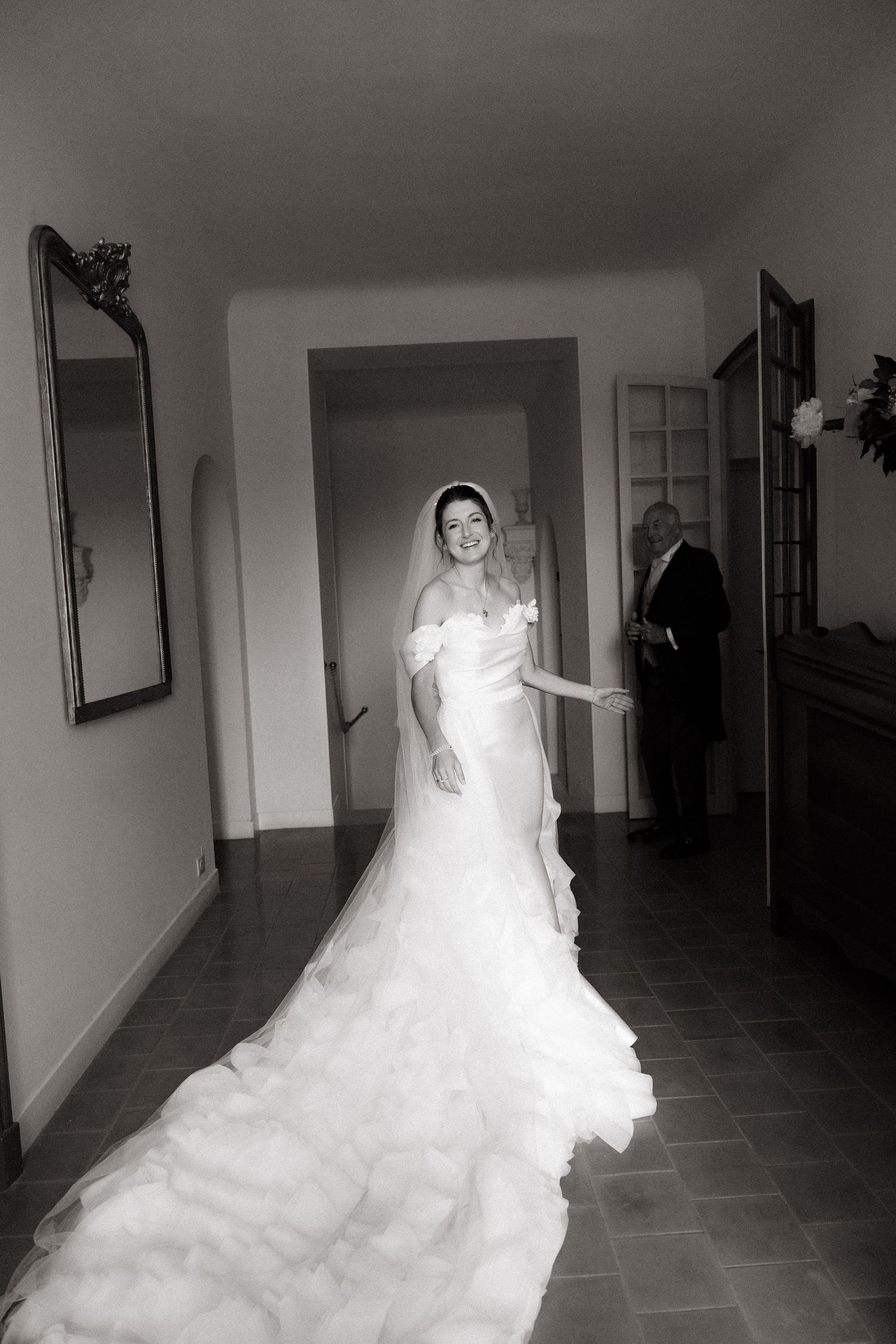 A sequence of black and white photos showing a bride in a flowing white dress walking down a hallway.