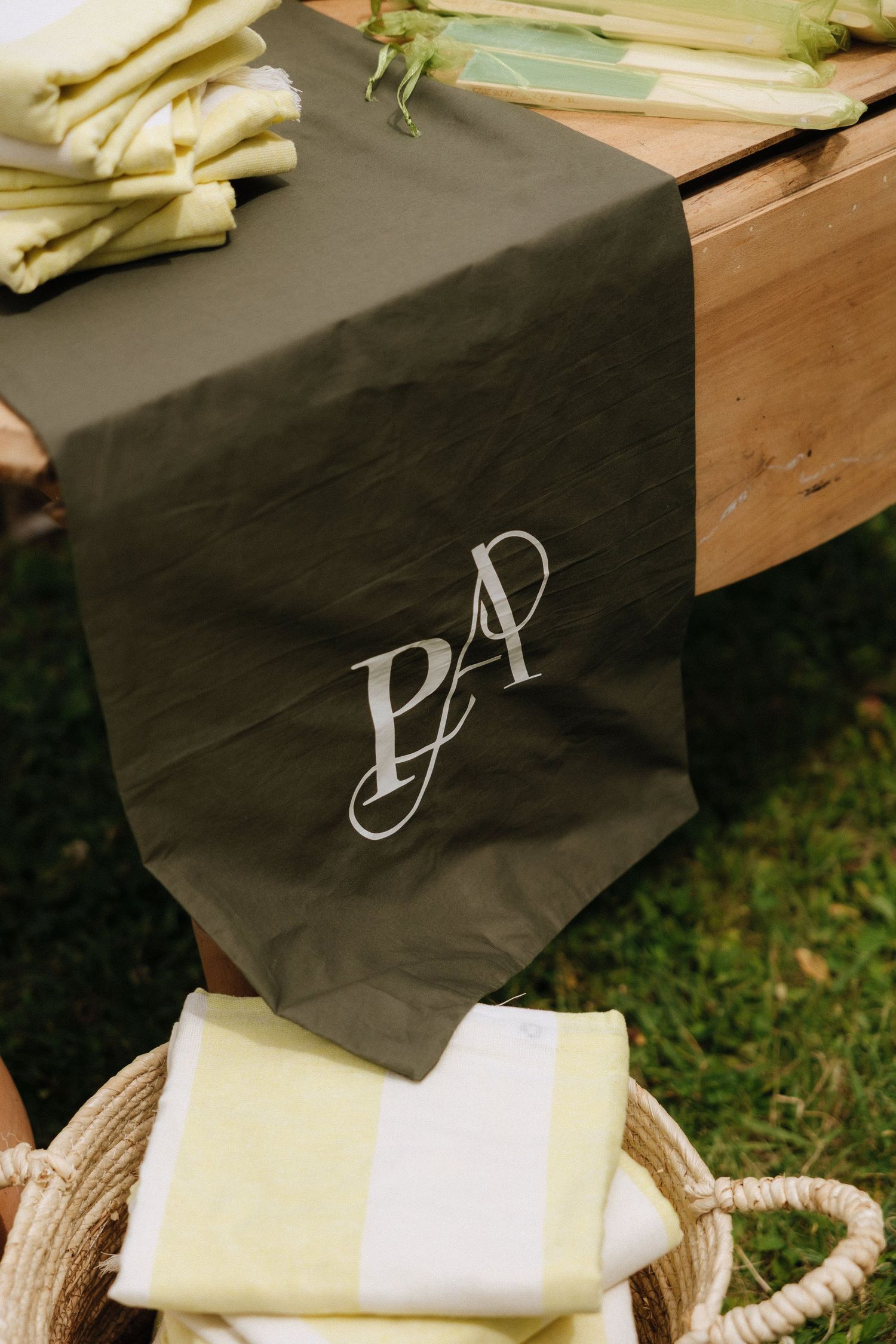 A decorative black table runner with monogrammed PA initials displayed at a wedding.