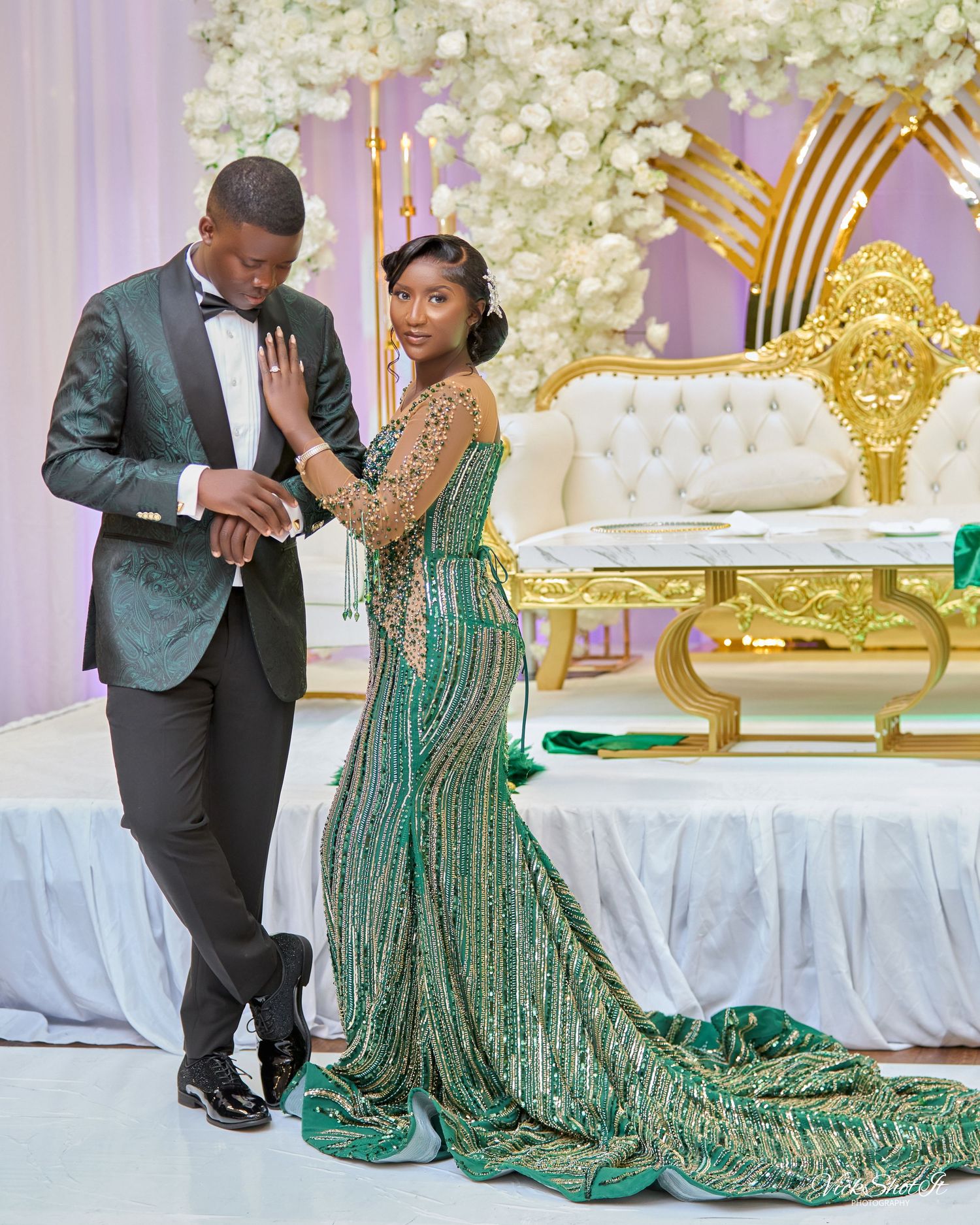 A couple in formal attire sharing romantic moments at their wedding reception.