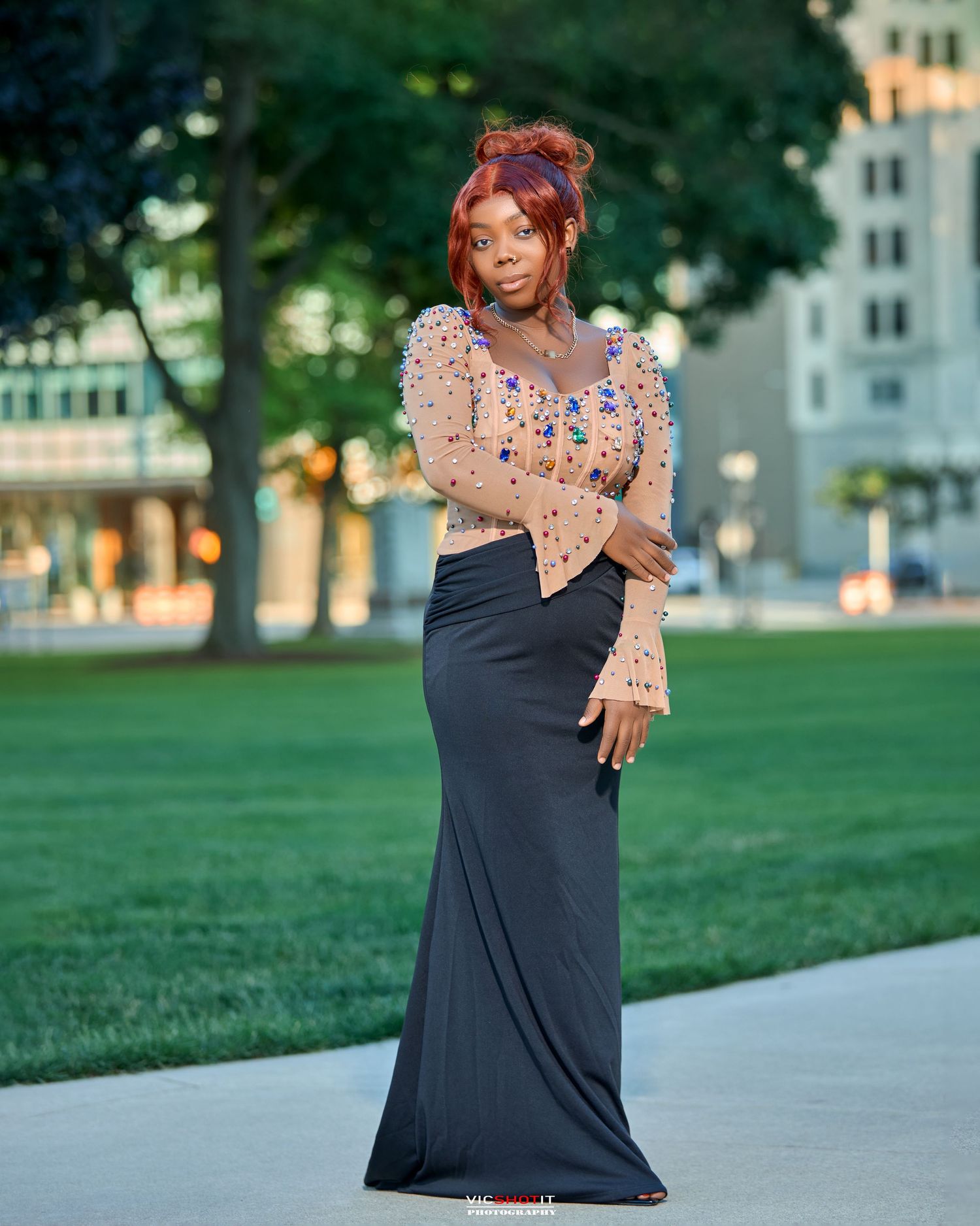 Fashion photography session showcasing a black dress with floral details in an outdoor setting.
