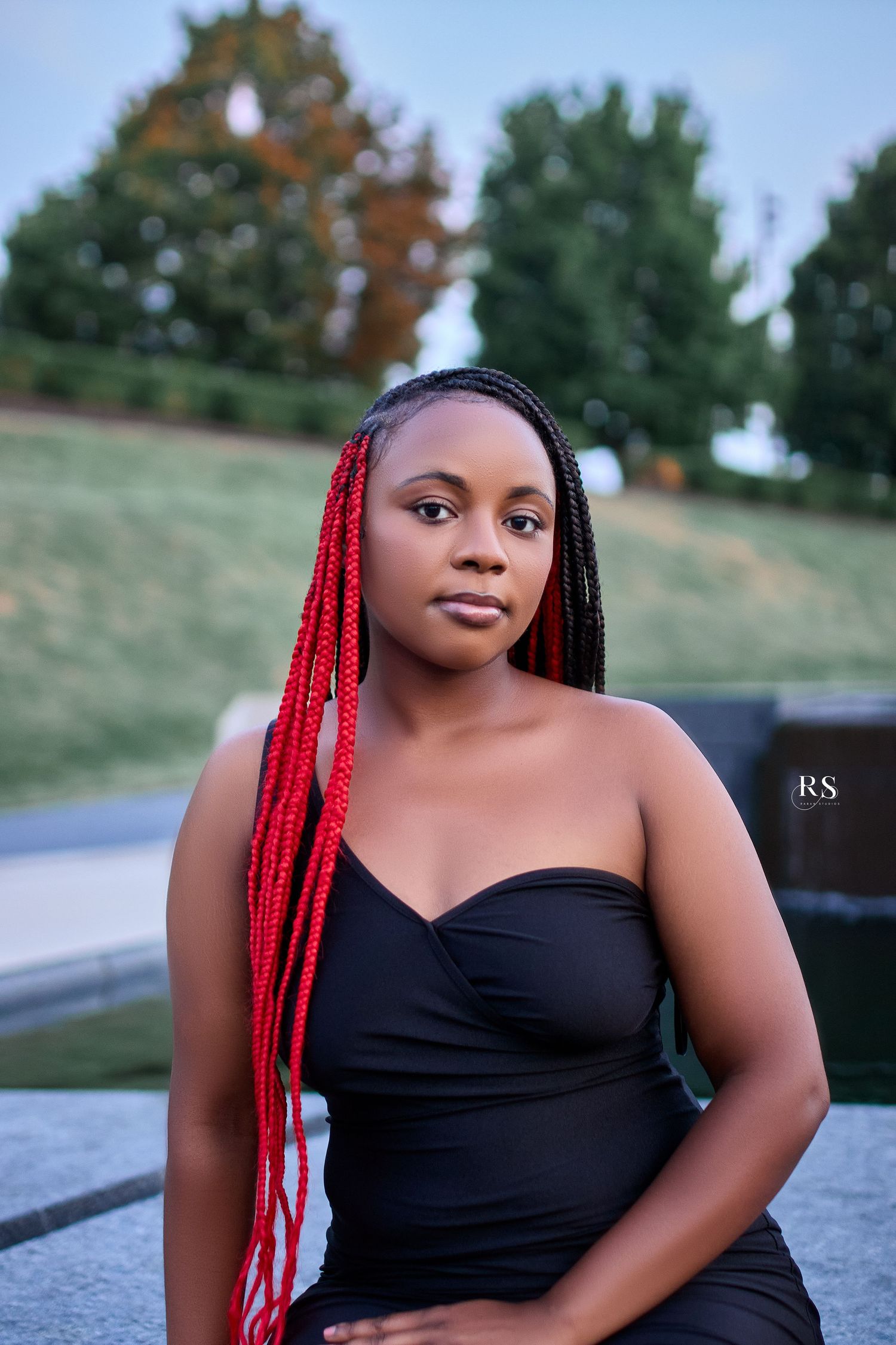 A portrait series showing a person in a black top with vibrant red braids posing outdoors.