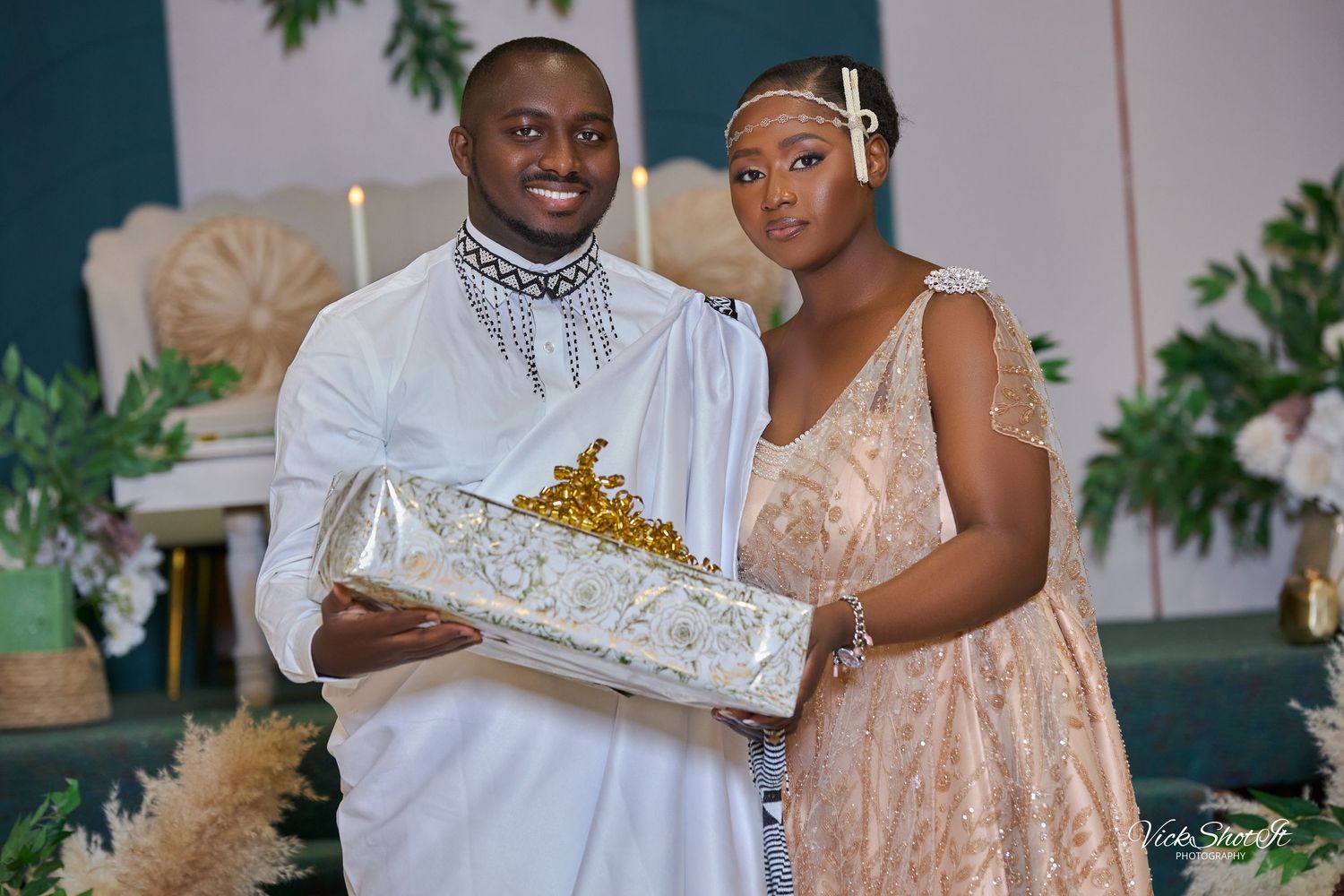 Wedding guests exchanging gifts in formal attire at an elegant reception.
