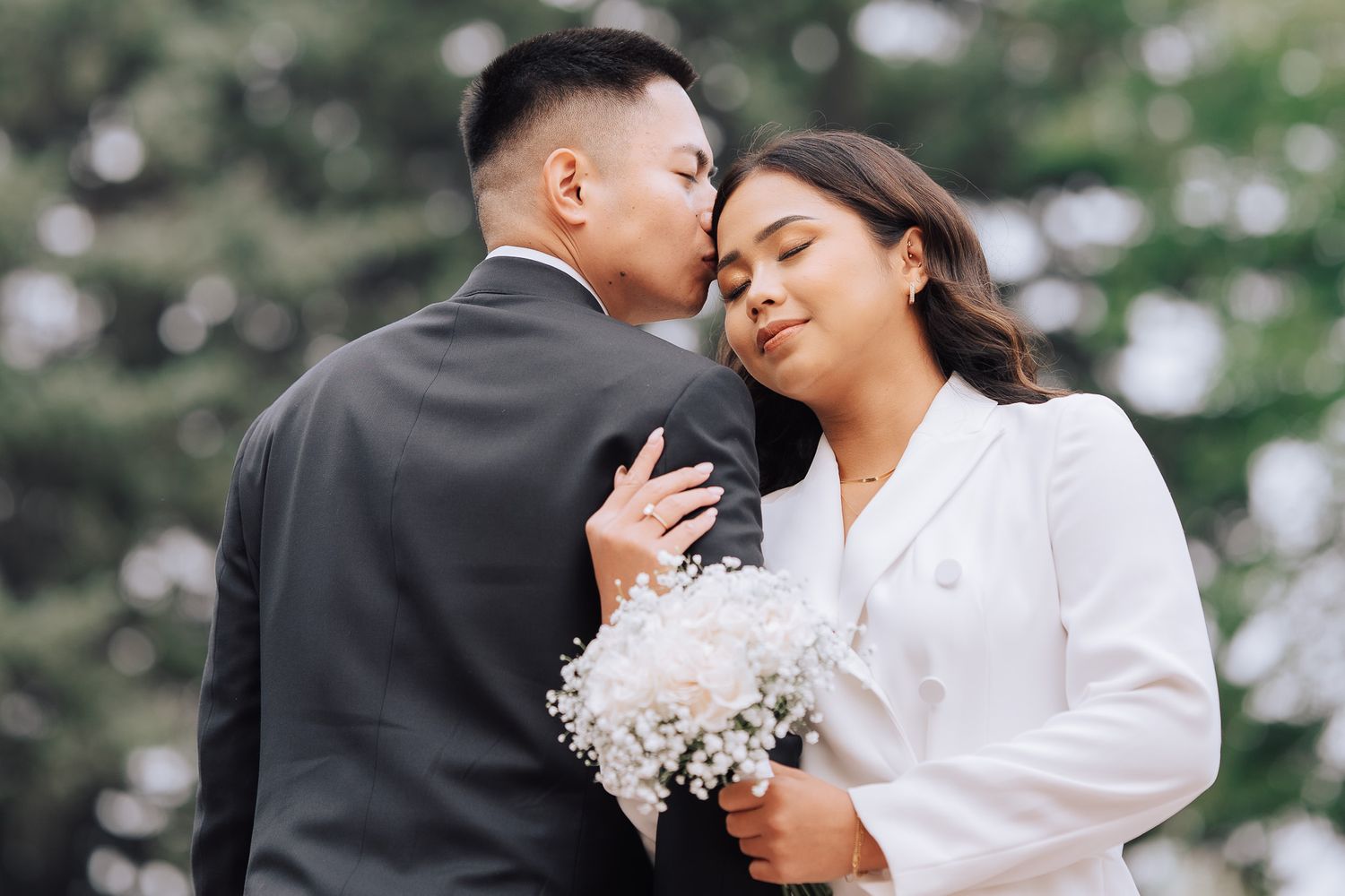 Bride & Groom hugging while holding hands with bokeh in dreamy bokeh background