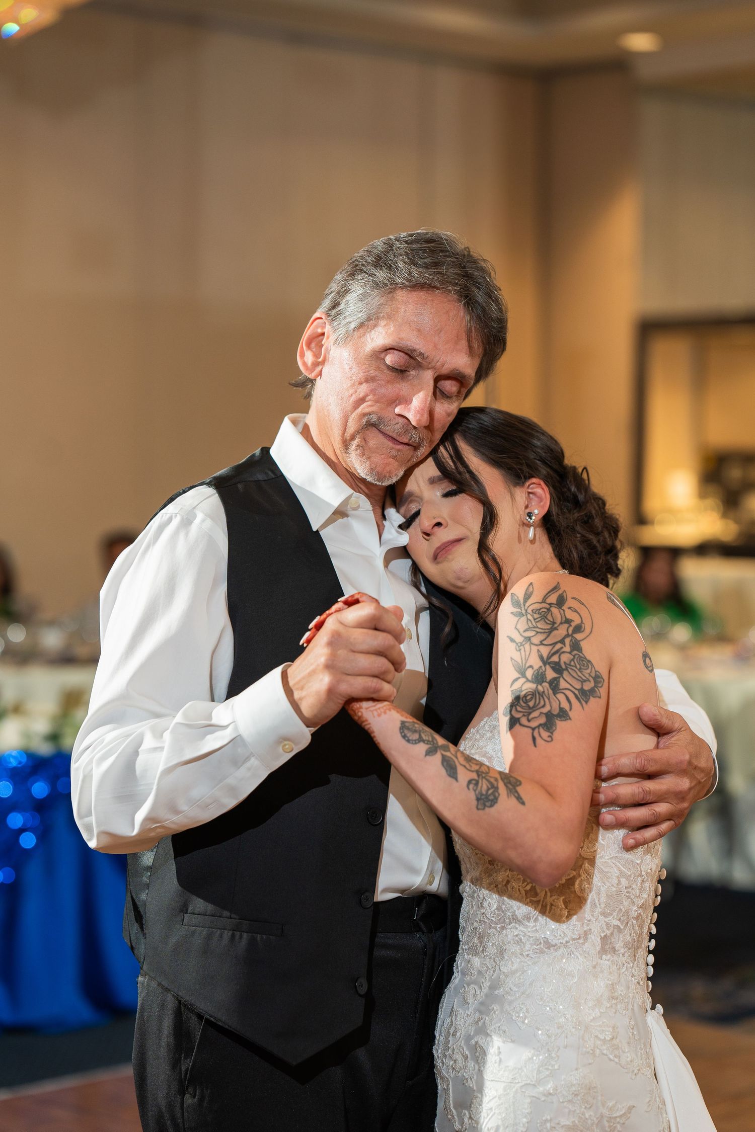 A tender father-daughter dance moment at a wedding reception.