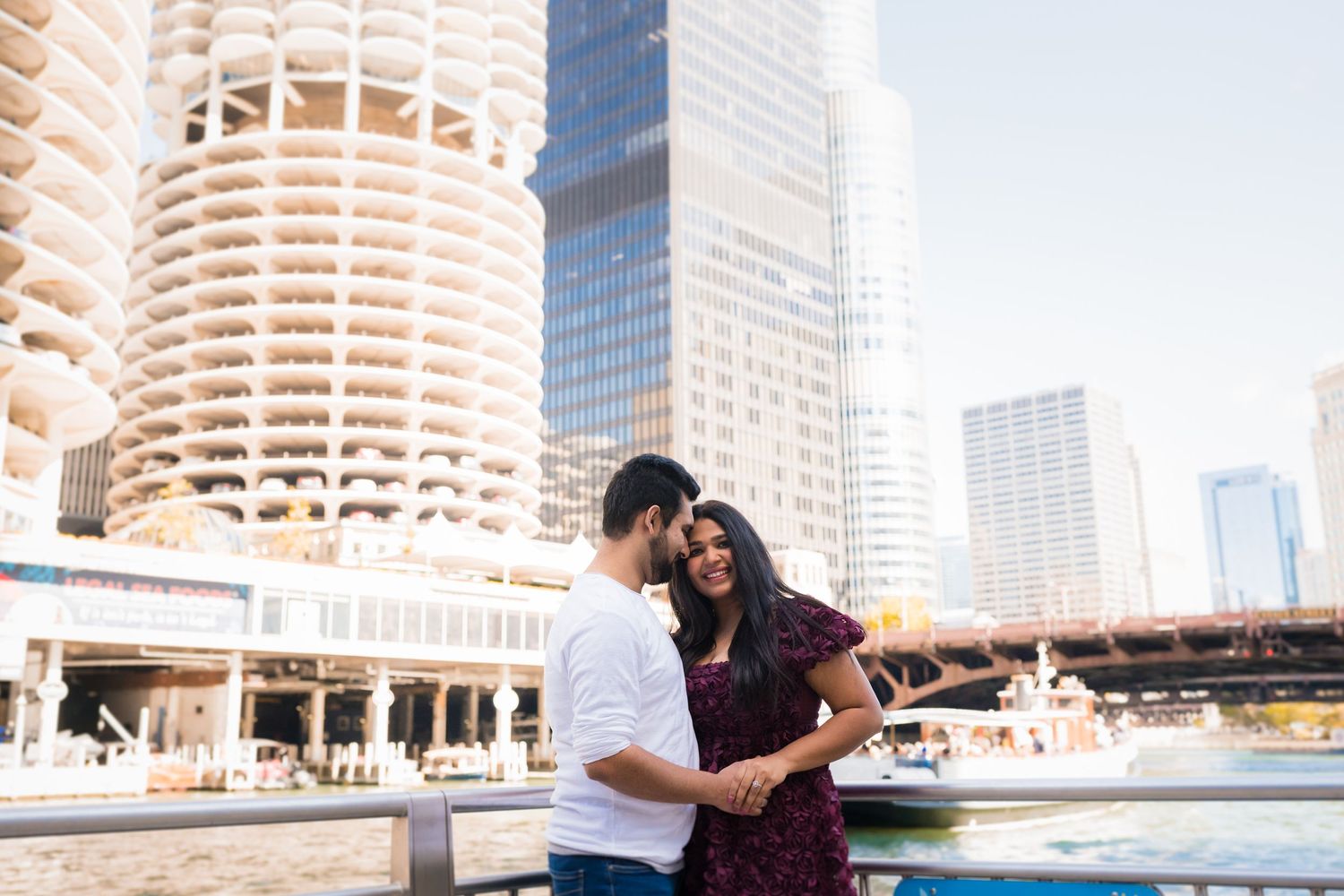 A couple shares a tender moment by Marina City's distinctive corn cob towers in downtown Chicago.