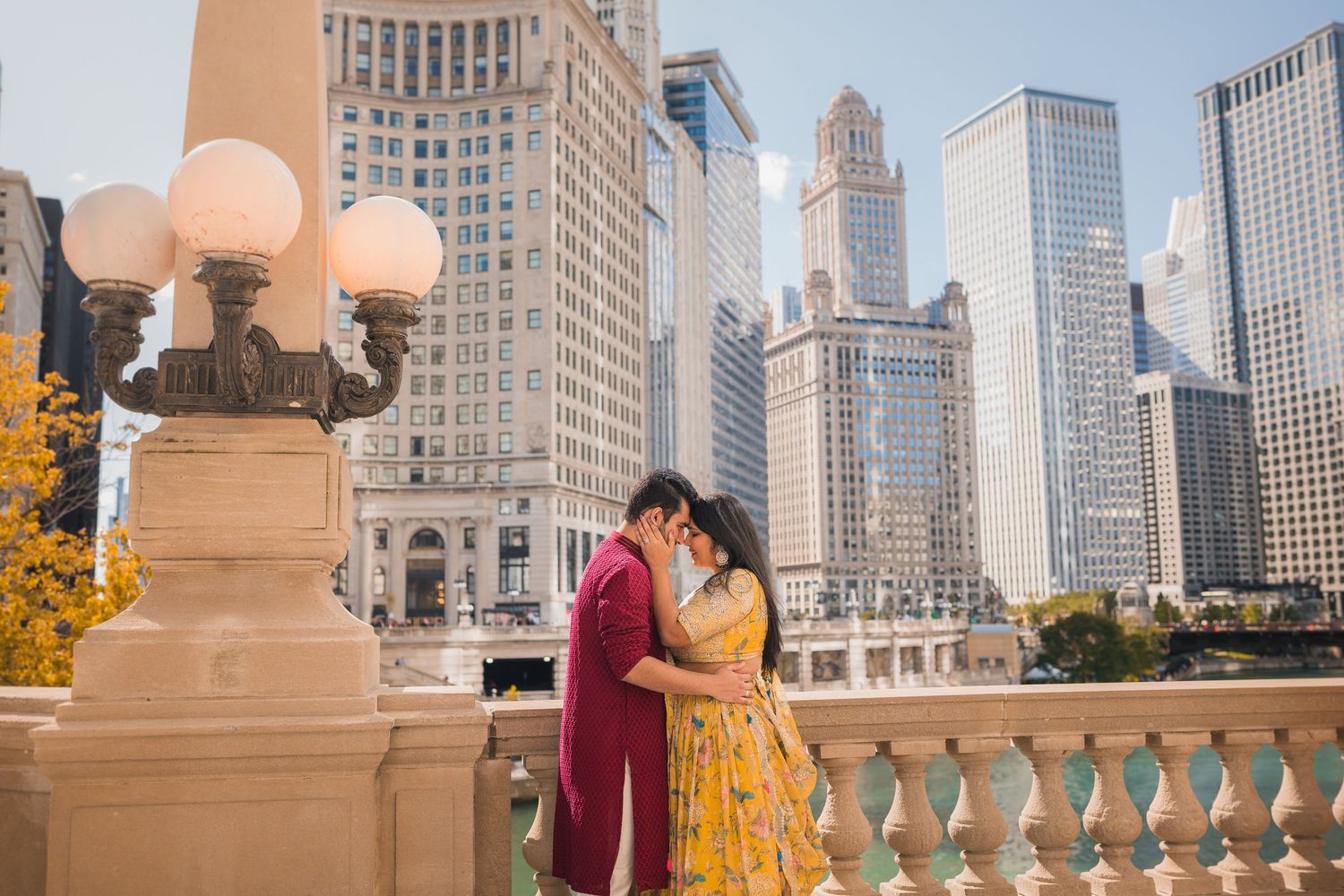 A romantic photoshoot on a Chicago terrace with skyscrapers and vintage lamp posts in the background.
