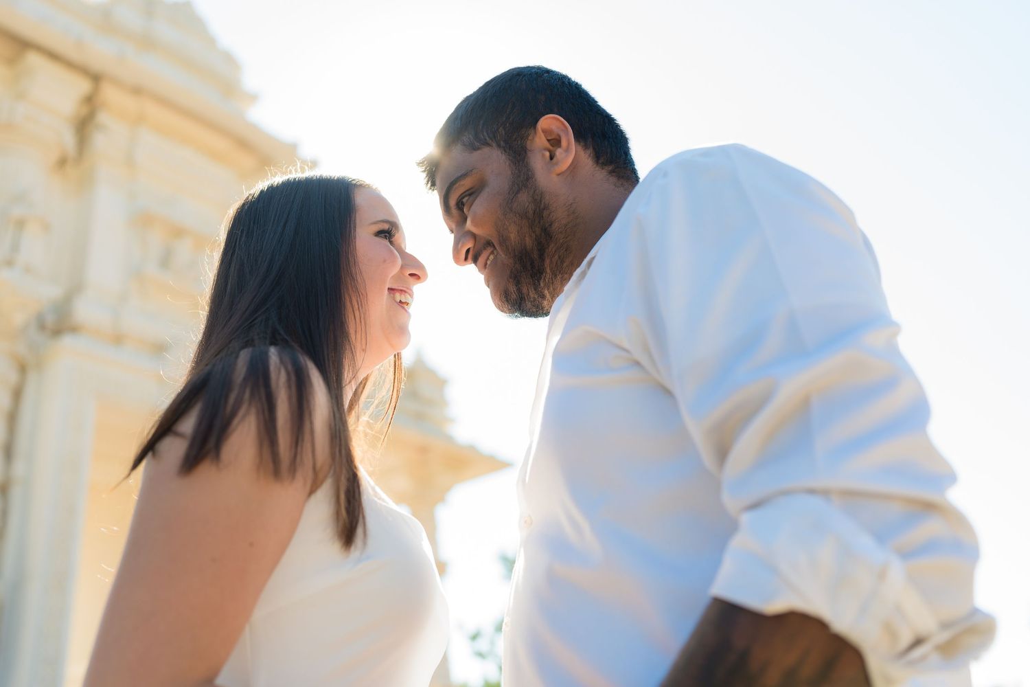 Couple sharing a joyful moment during their outdoor wedding photoshoot.