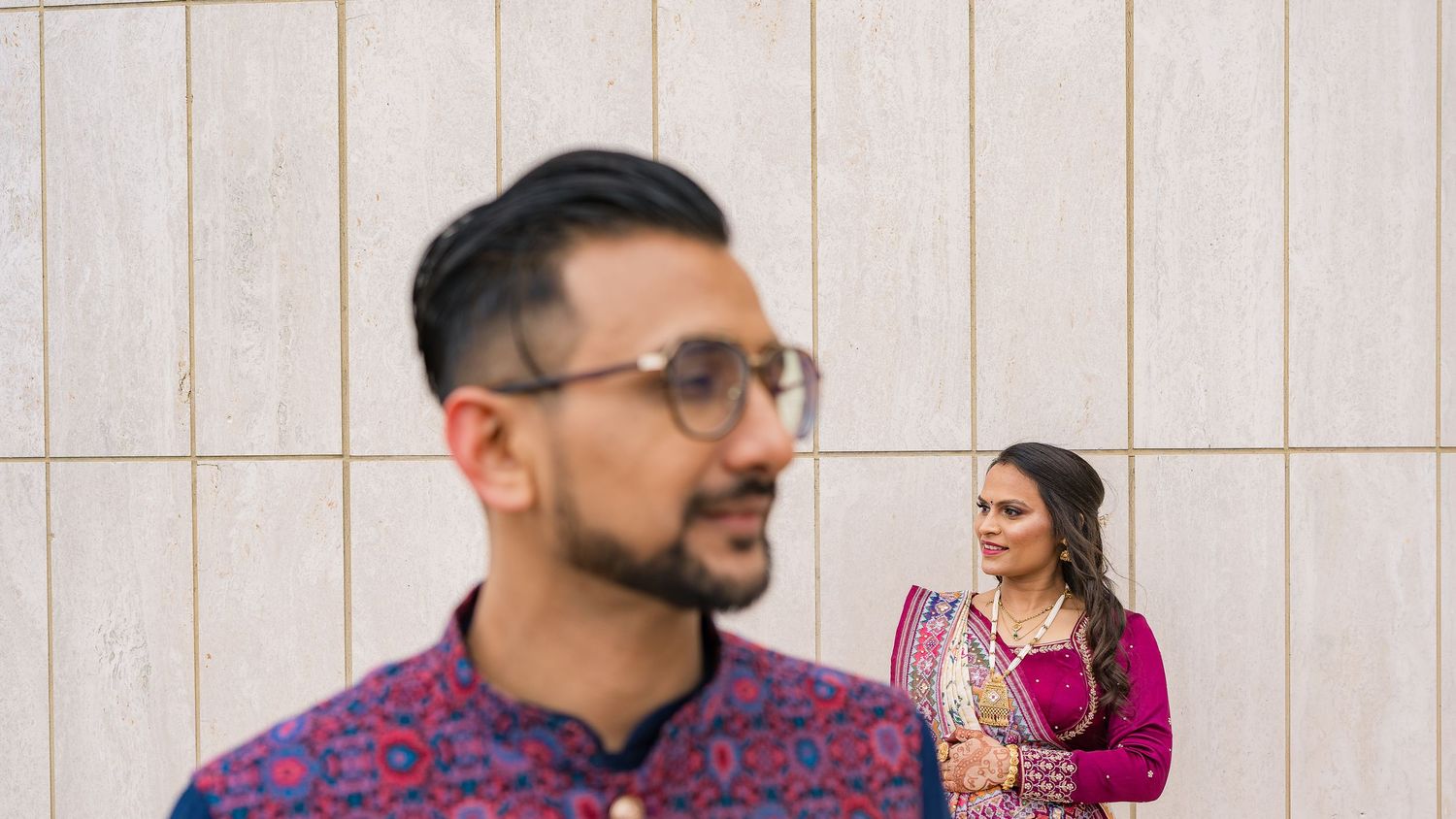 Creative portrait composition of couple in traditional South Asian wedding attire.