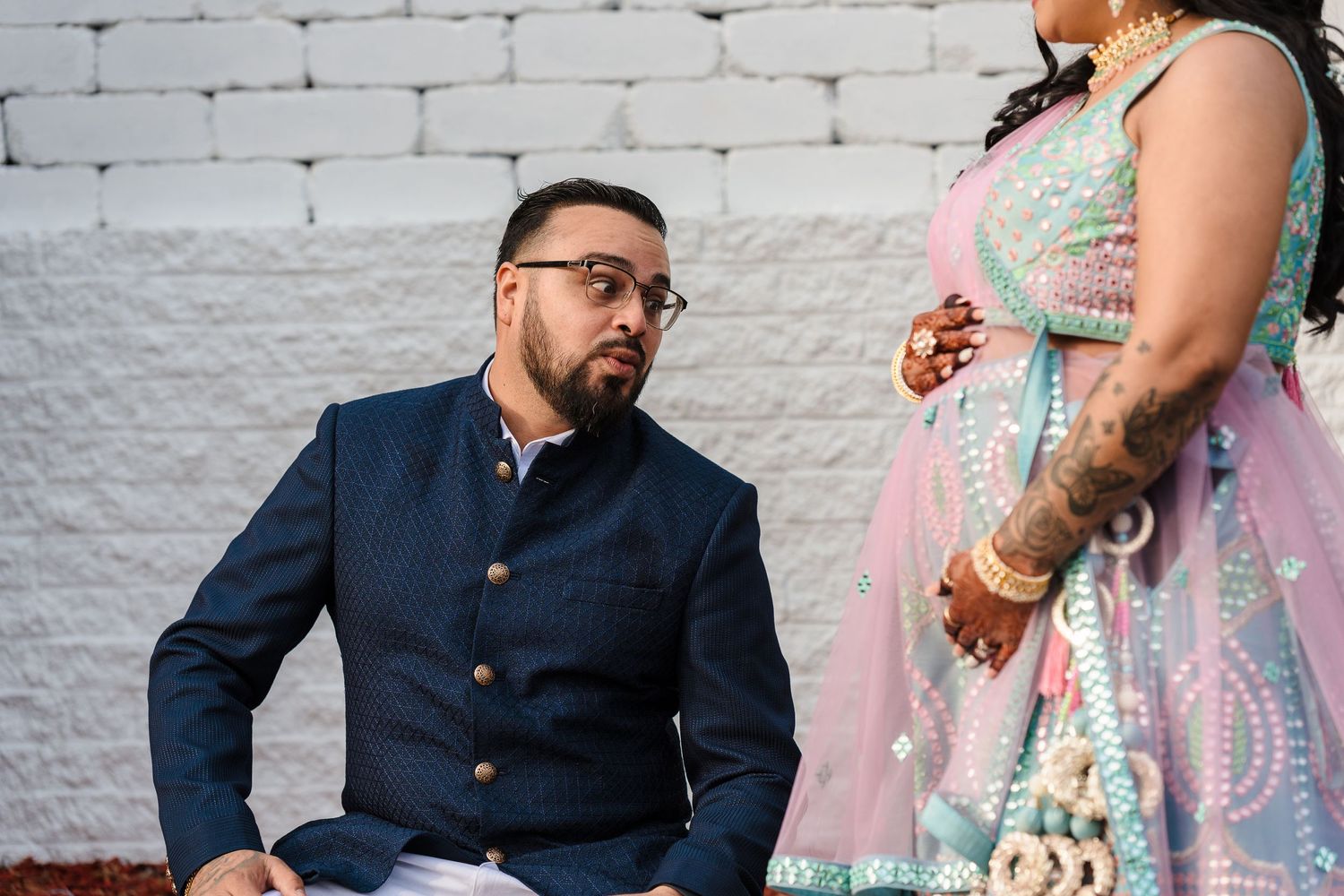 Close-up shot of a couple in formal Indian fusion wear having an intimate moment.