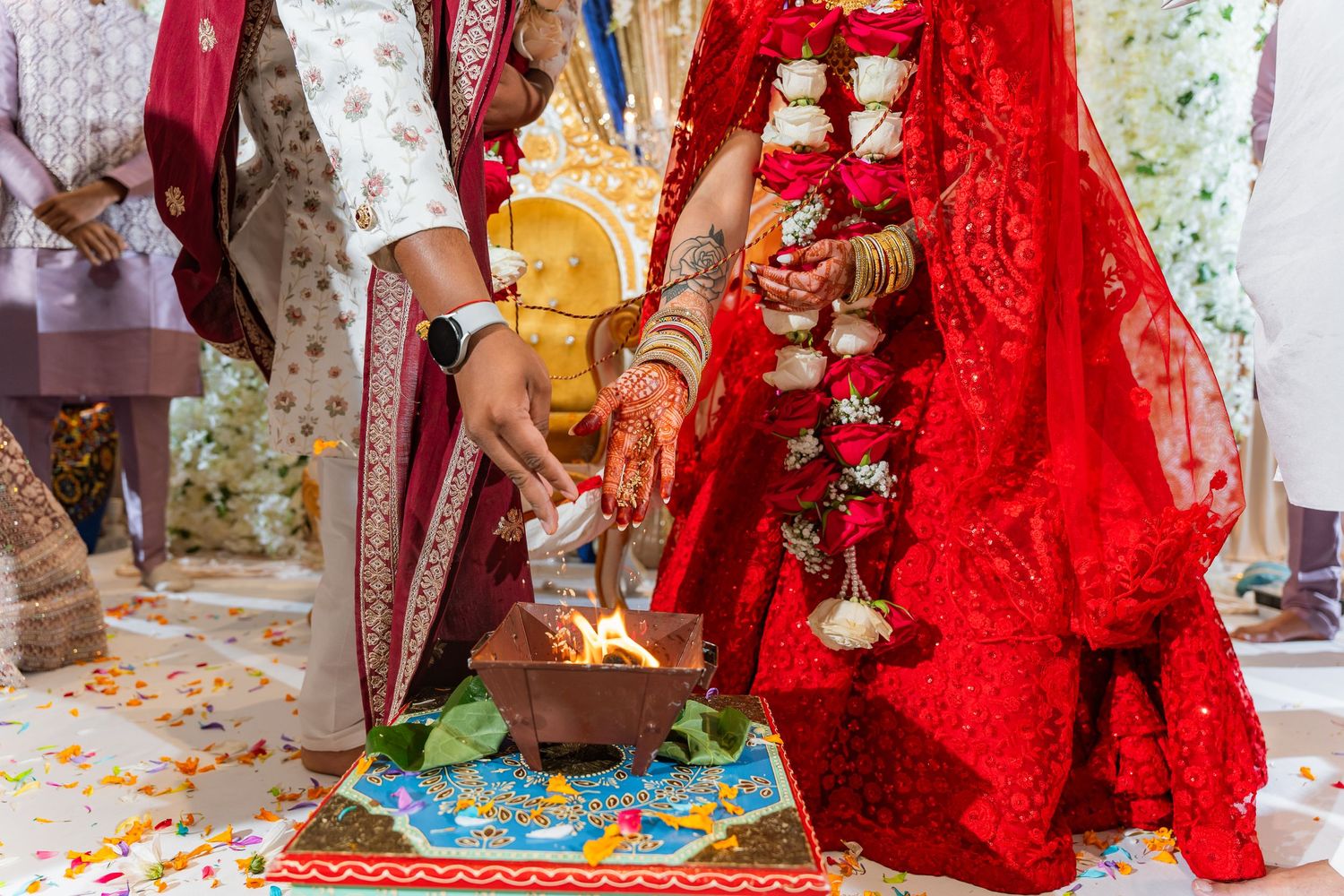 Traditional Indian wedding ceremony rituals with ornate decorations and rich red fabrics.