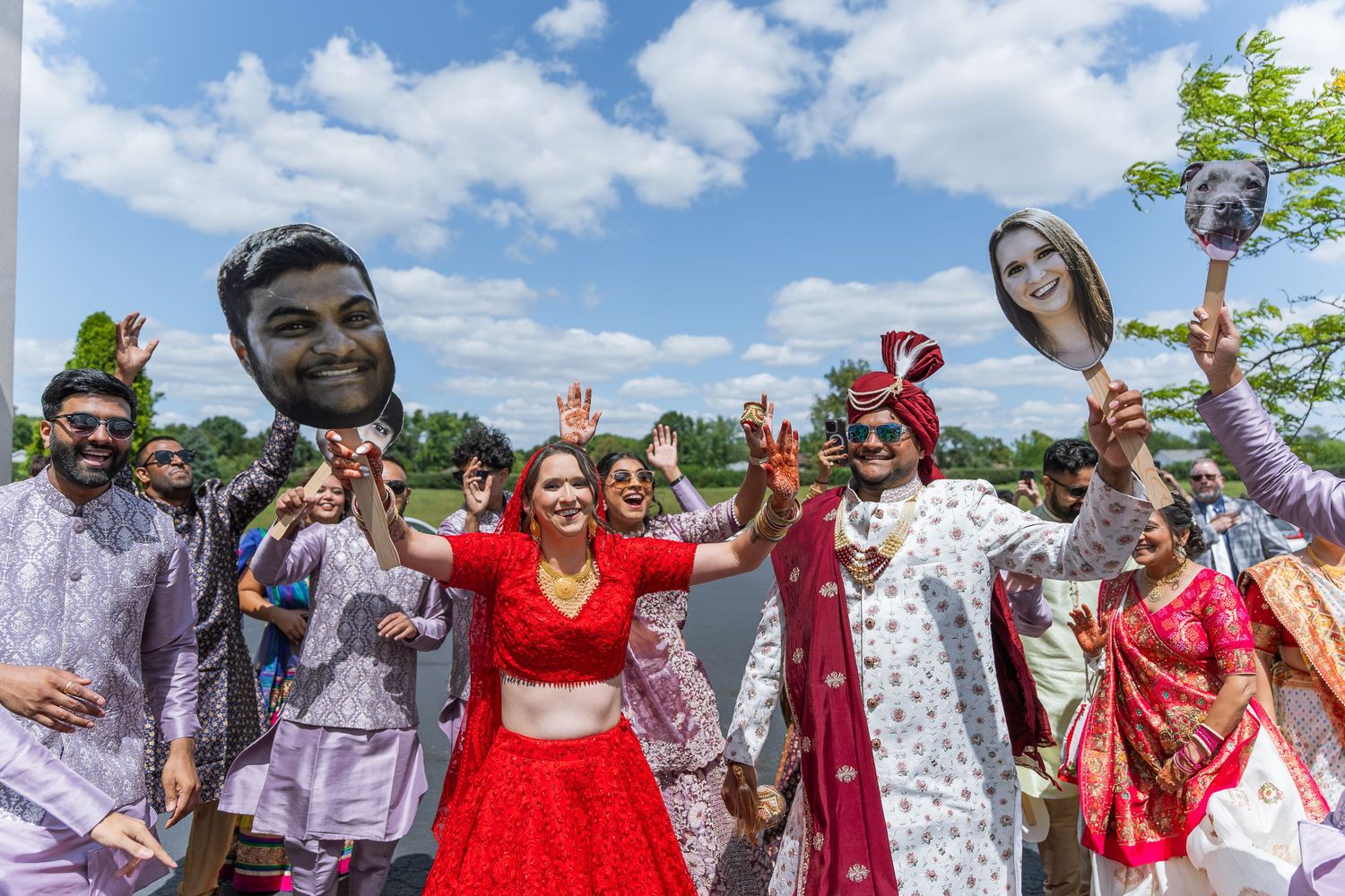 Colorful outdoor celebration with guests in traditional Indian and Western attire.