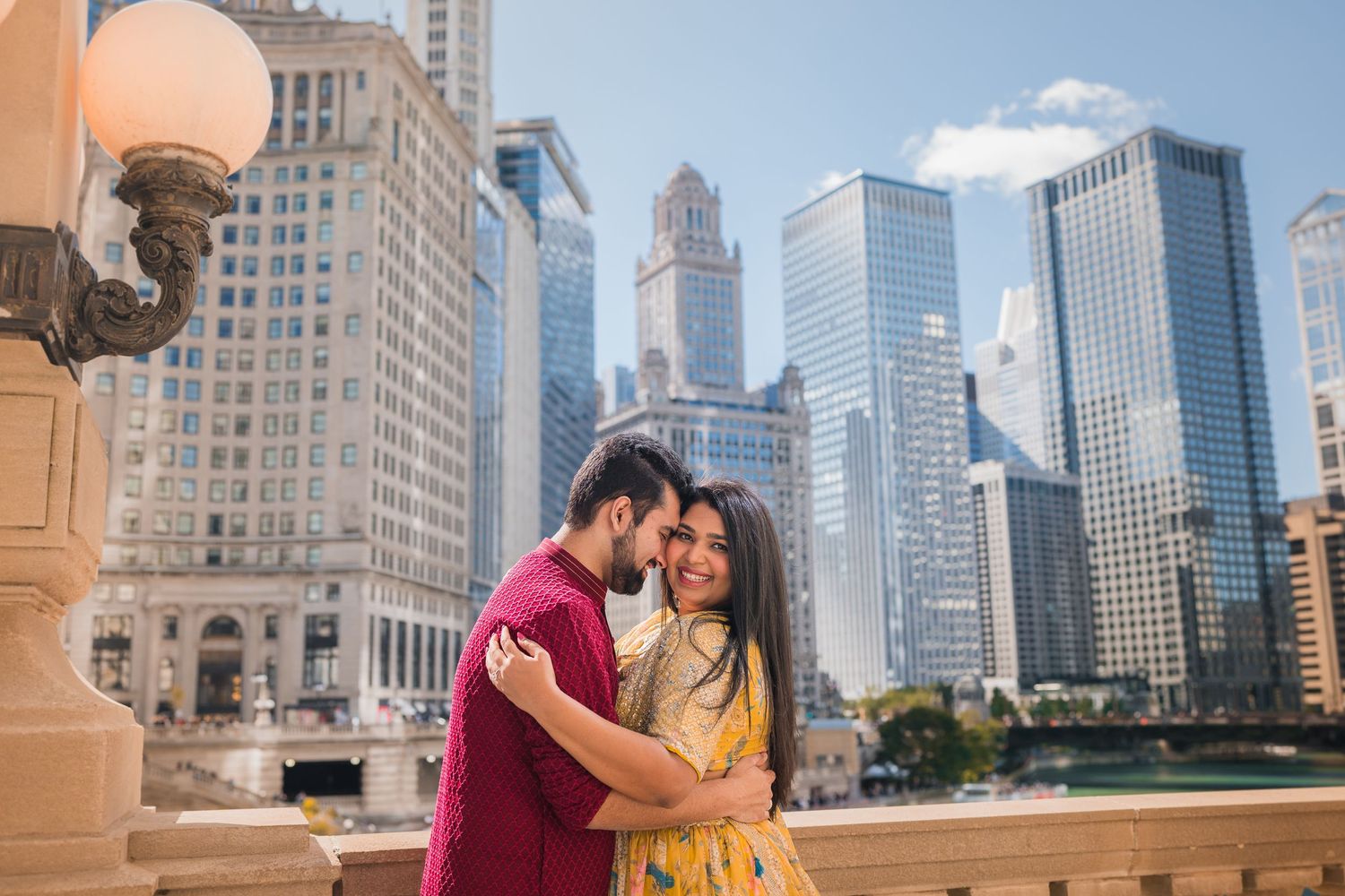 Romantic moment against Chicago skyline with vintage lamp post in foreground.