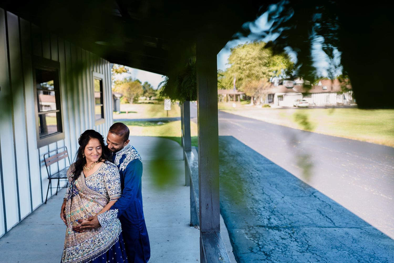 Intimate portrait on a covered porch with elegant formal attire.