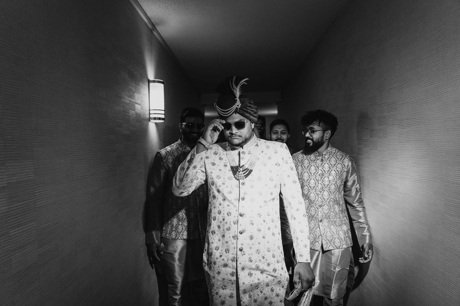 Dramatic black and white corridor scene with traditional wedding attire.