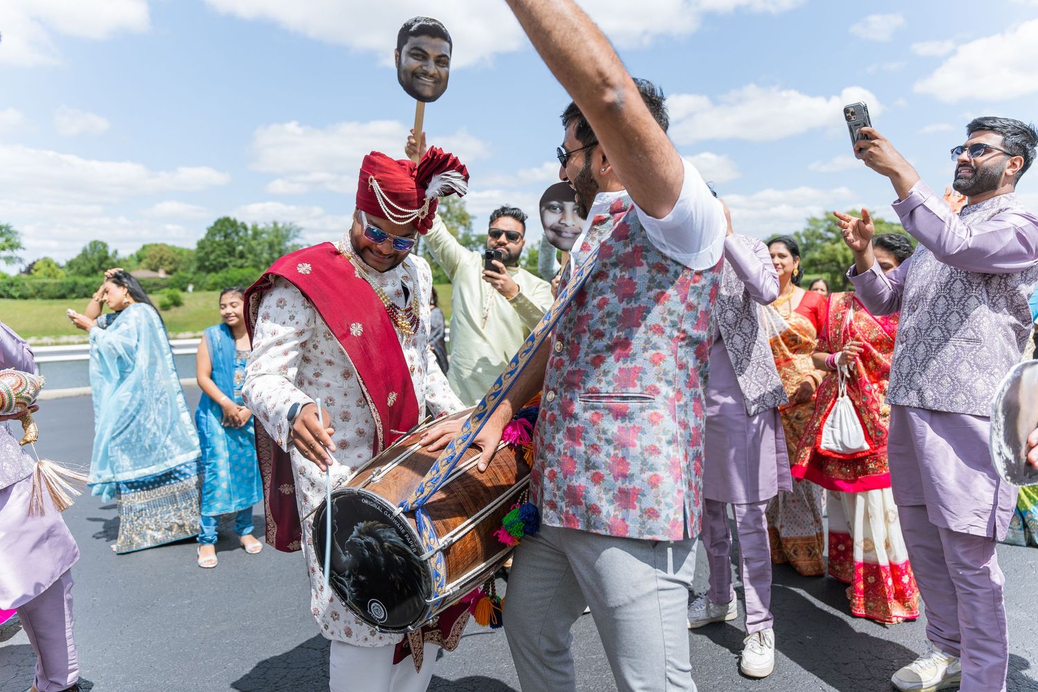 Celebratory dancing and music at a vibrant outdoor Indian wedding ceremony.