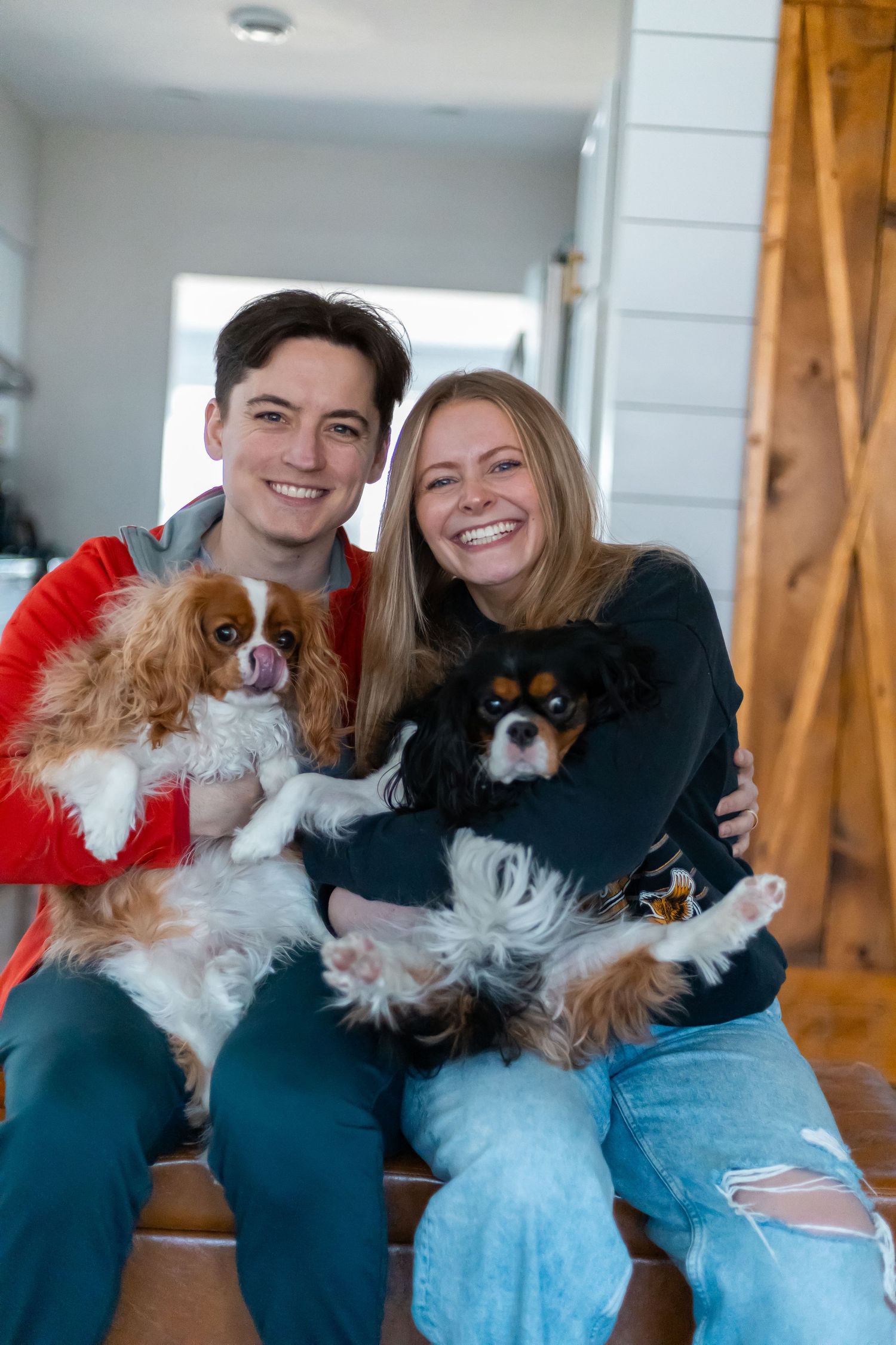 Couples portrait holding dogs
