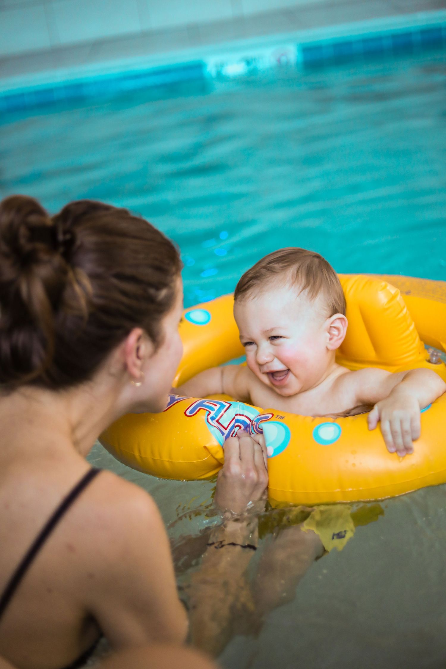 Mother and baby laughing in the pool