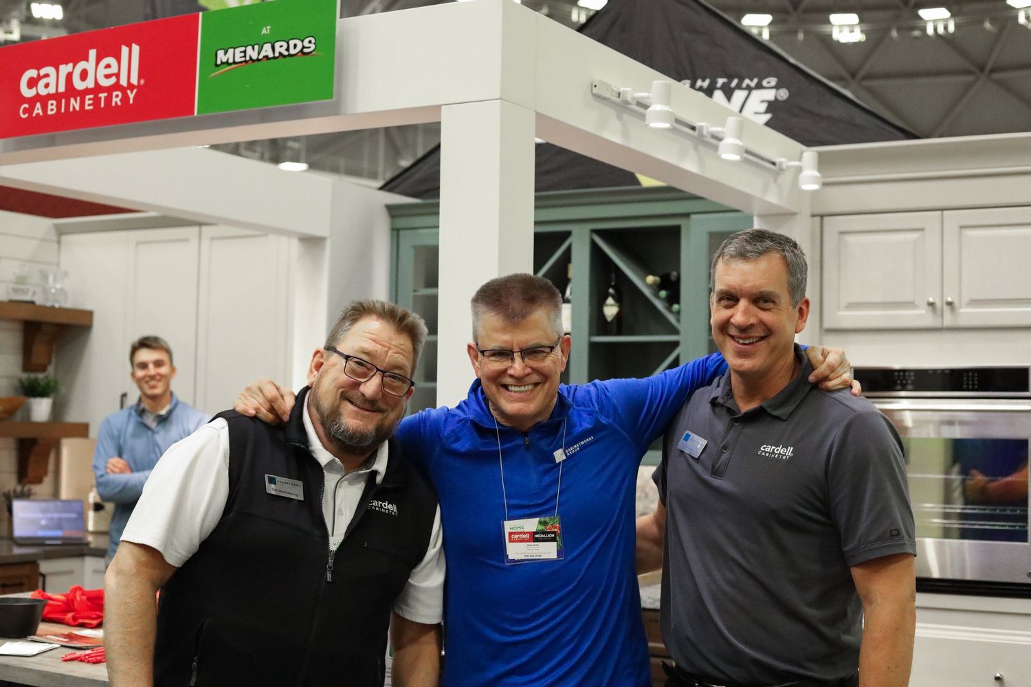 Three men standing in front of their event booth