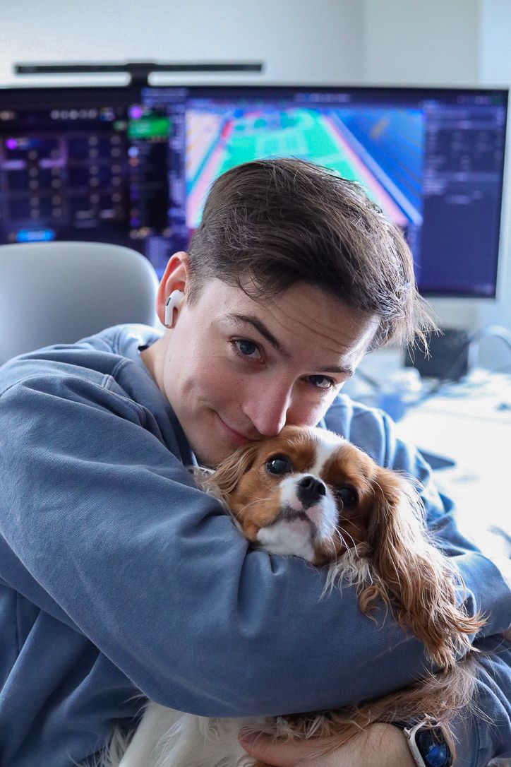 A man holding his dog close
