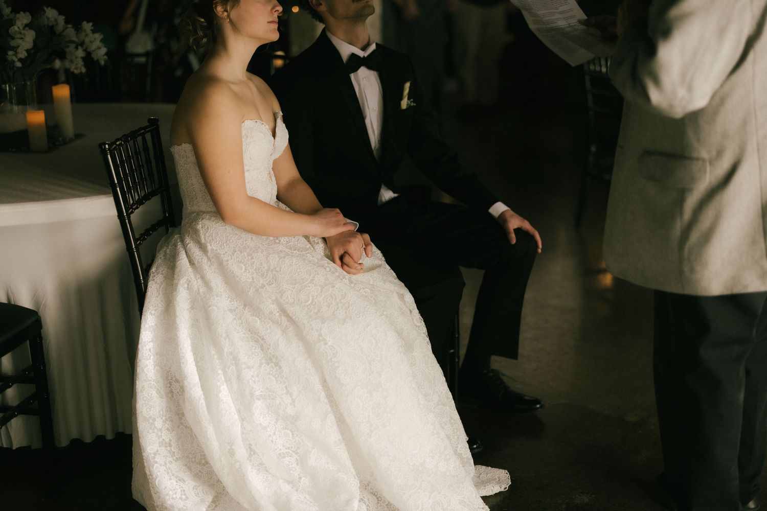 A couple in formal wedding attire share an intimate dance together during their wedding reception.