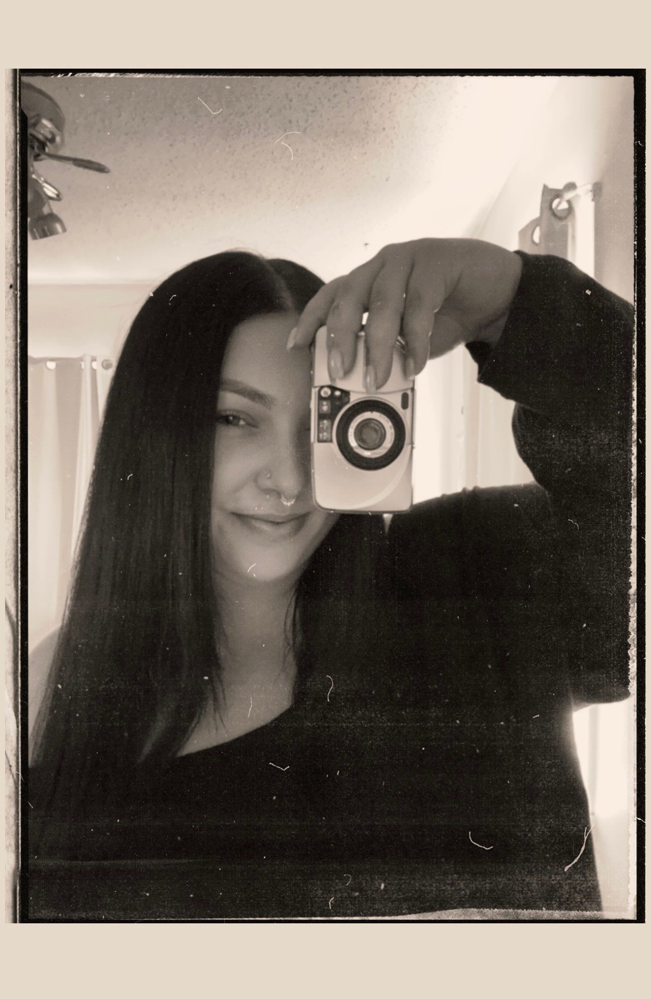 A series of monochromatic self-portrait style photos shows a person with long dark hair posing with a black cat.