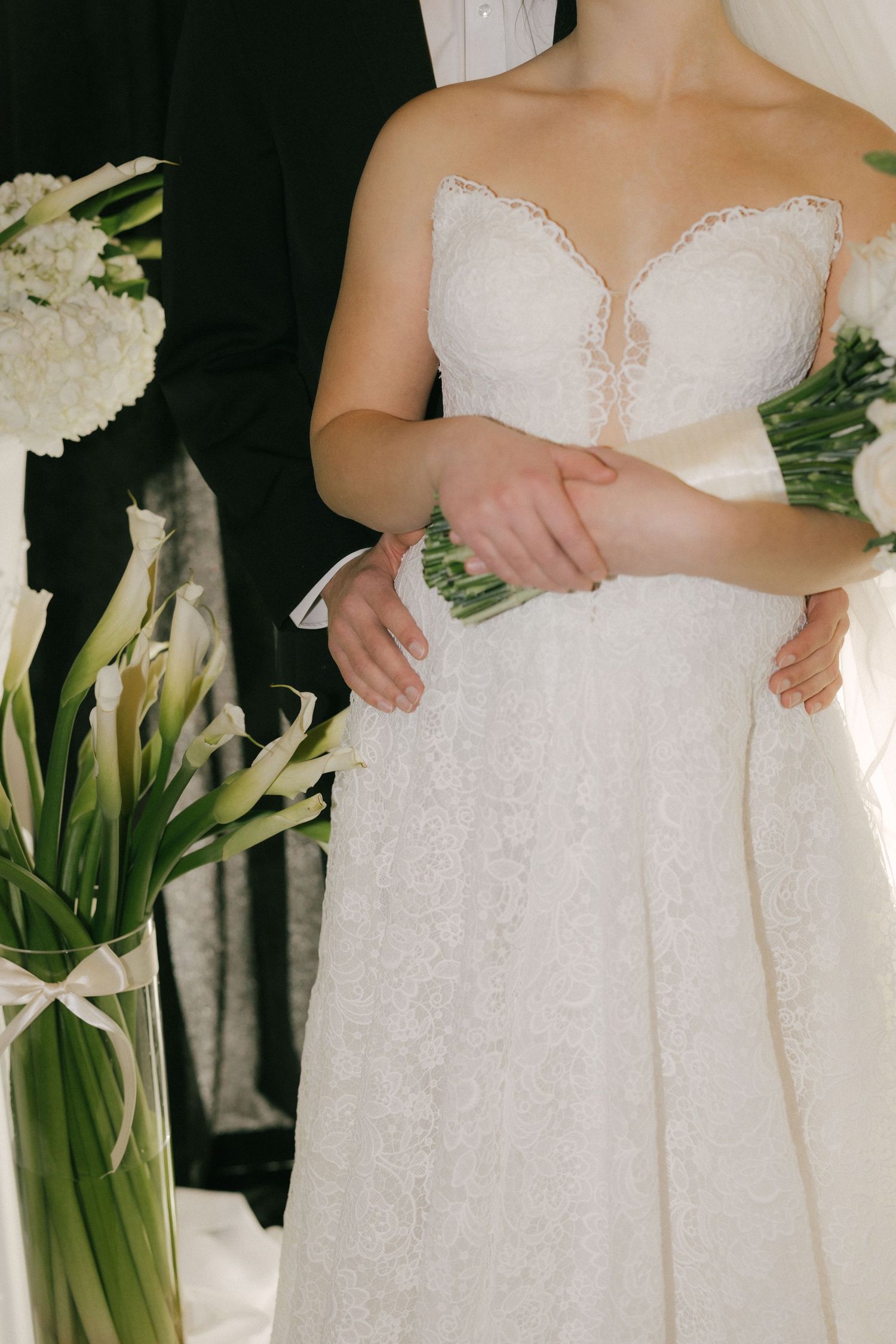 Close-up details of white lace wedding dress bodices with delicate floral patterns and off-shoulder designs.