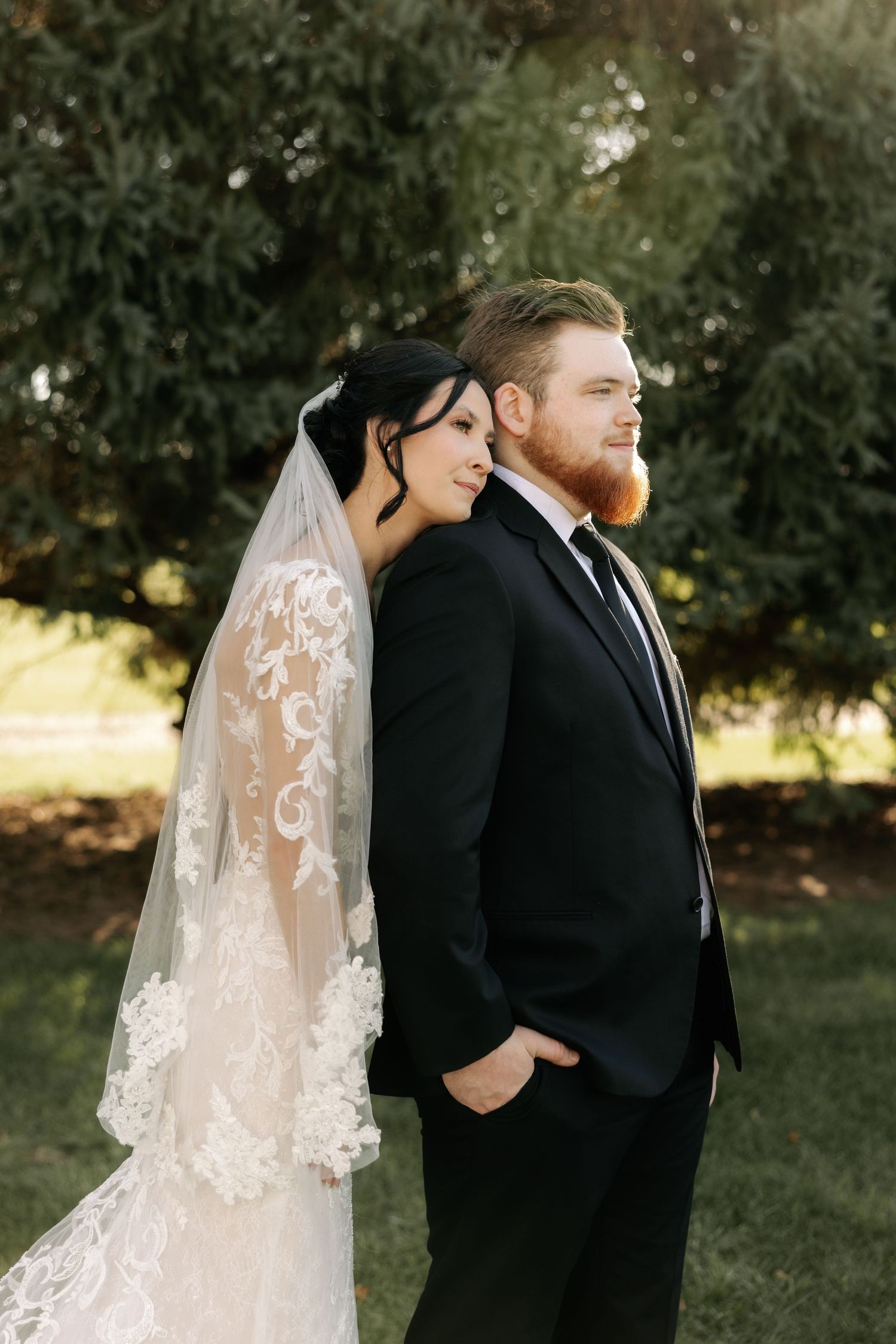 A romantic wedding photo series showing a couple in formal attire standing back-to-back outdoors.