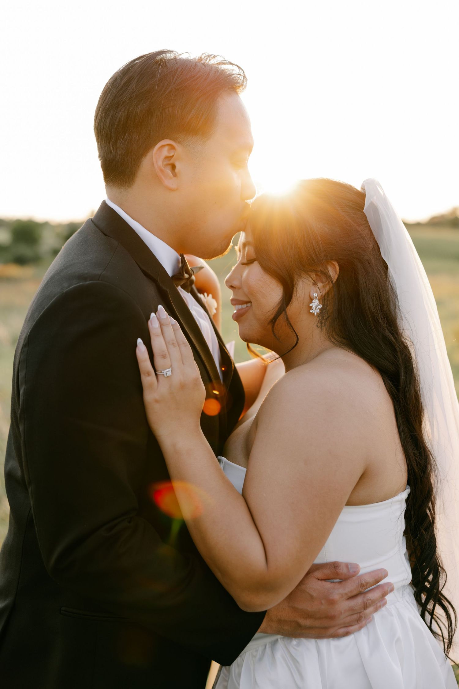 Romantic wedding couple sharing intimate kisses at sunset with golden sunlight streaming through the photos.