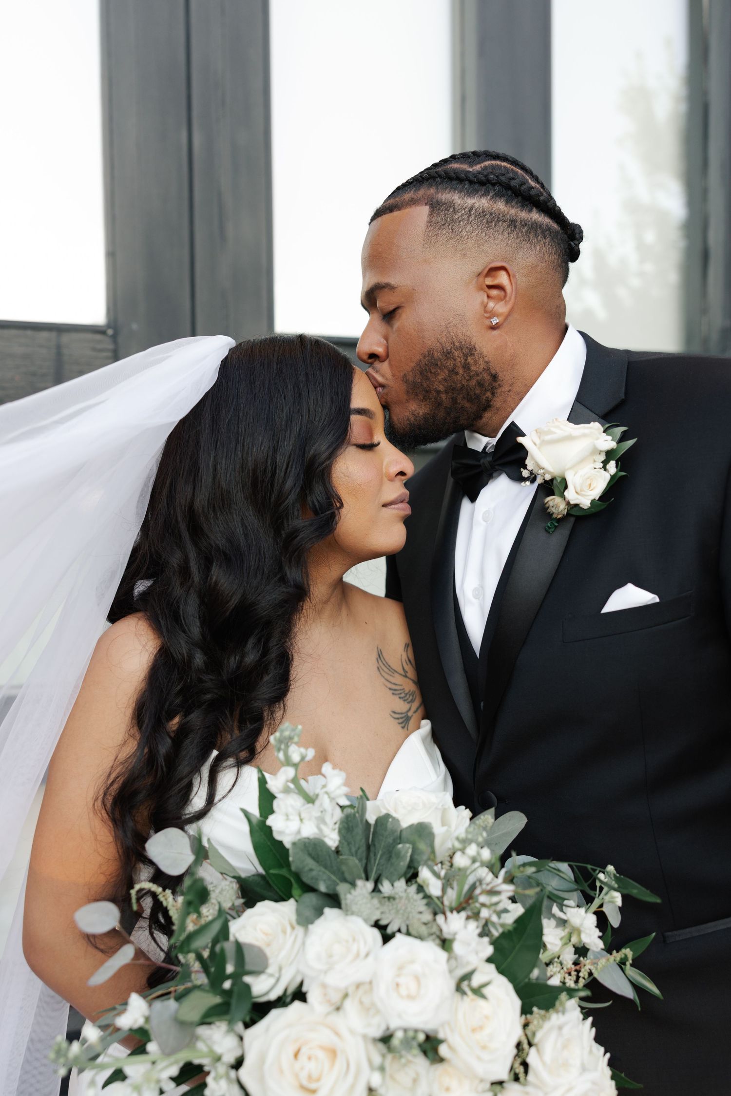 A romantic wedding photoshoot sequence showing tender moments between a couple with white flowers and greenery bouquet.