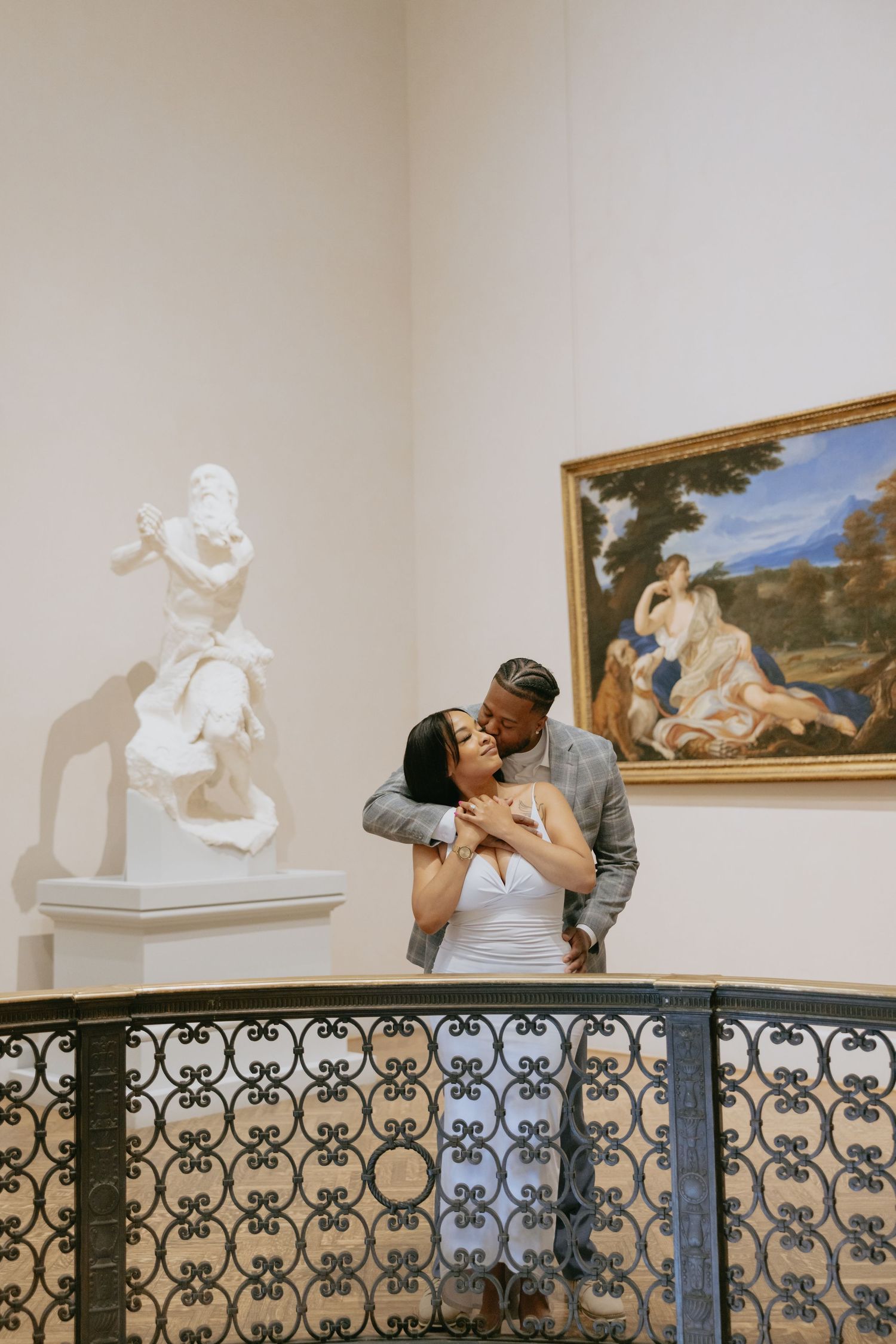 Art museum couple leans over ornate railing while playfully posing in black and white photo collage.