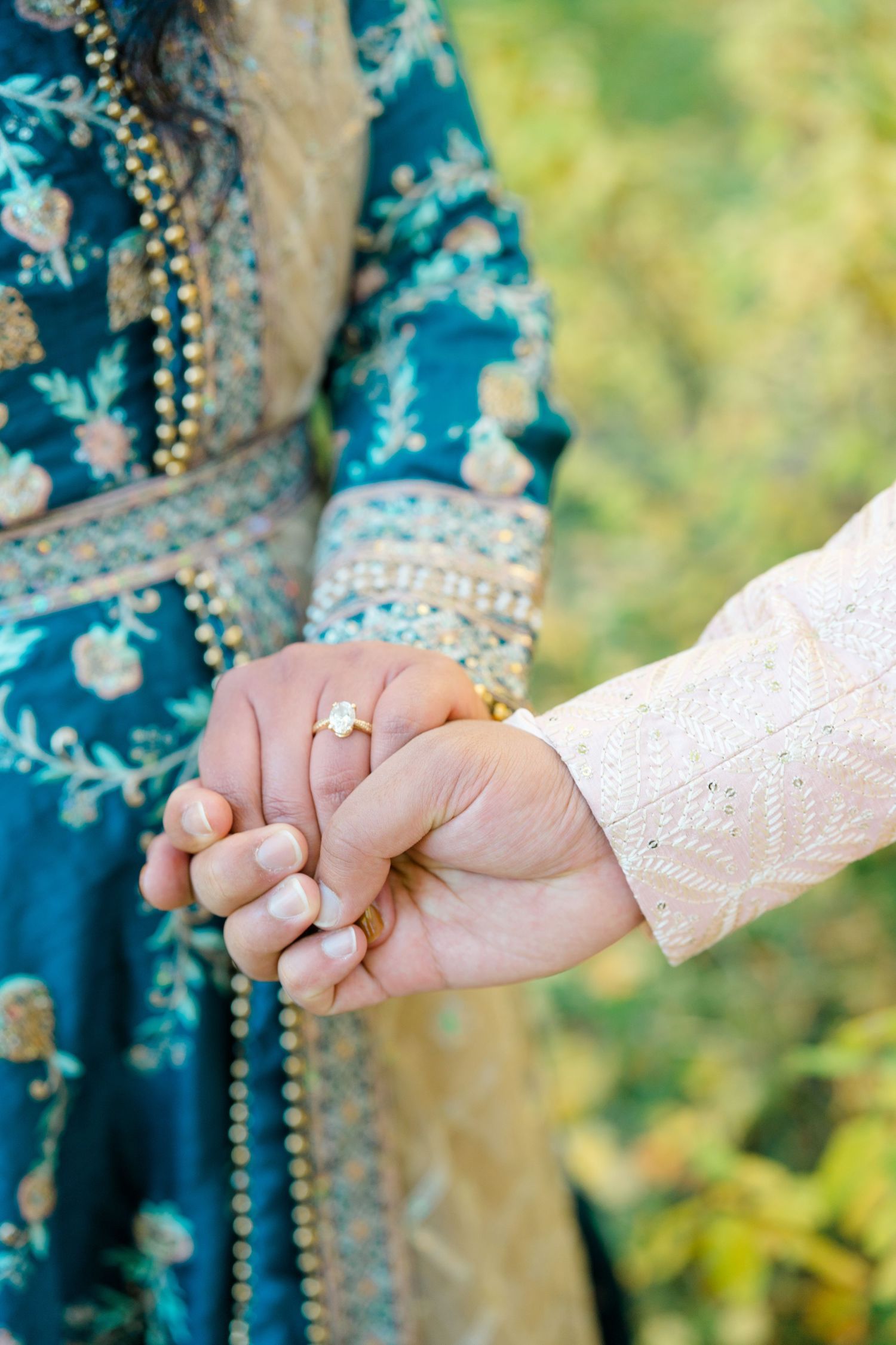 Close-up series of hands holding each other showing engagement ring details against a blurred natural background.