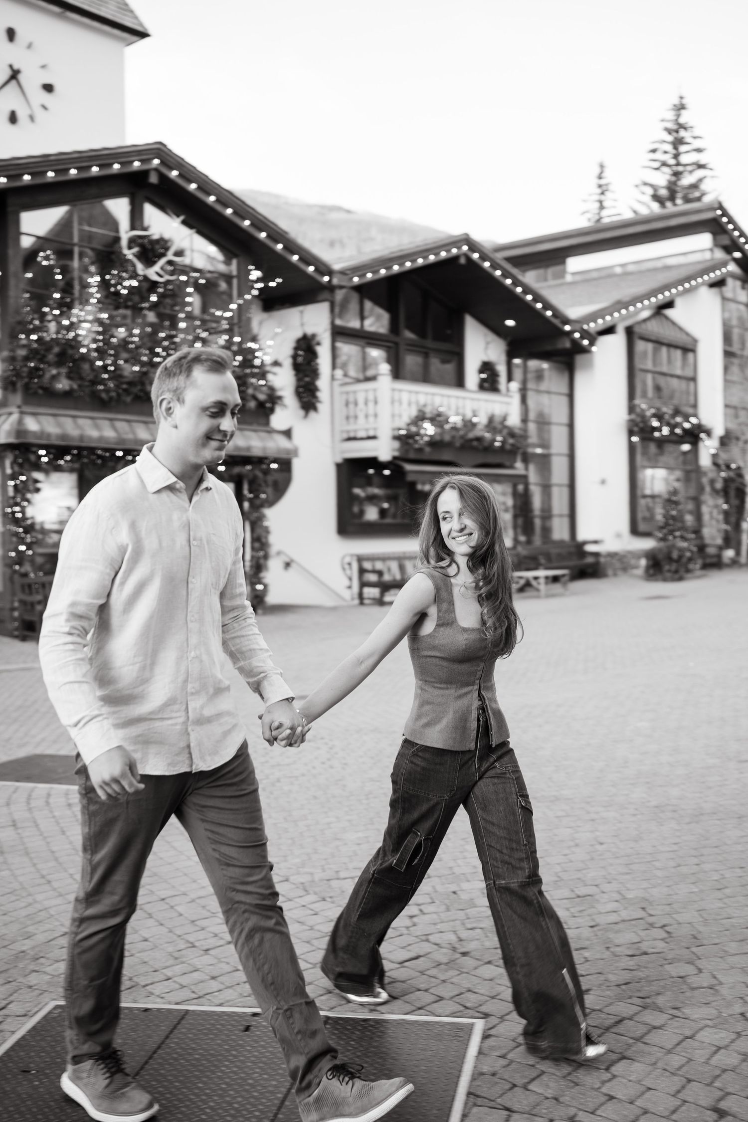 A playful series of dance moves captured in black and white on a brick courtyard.