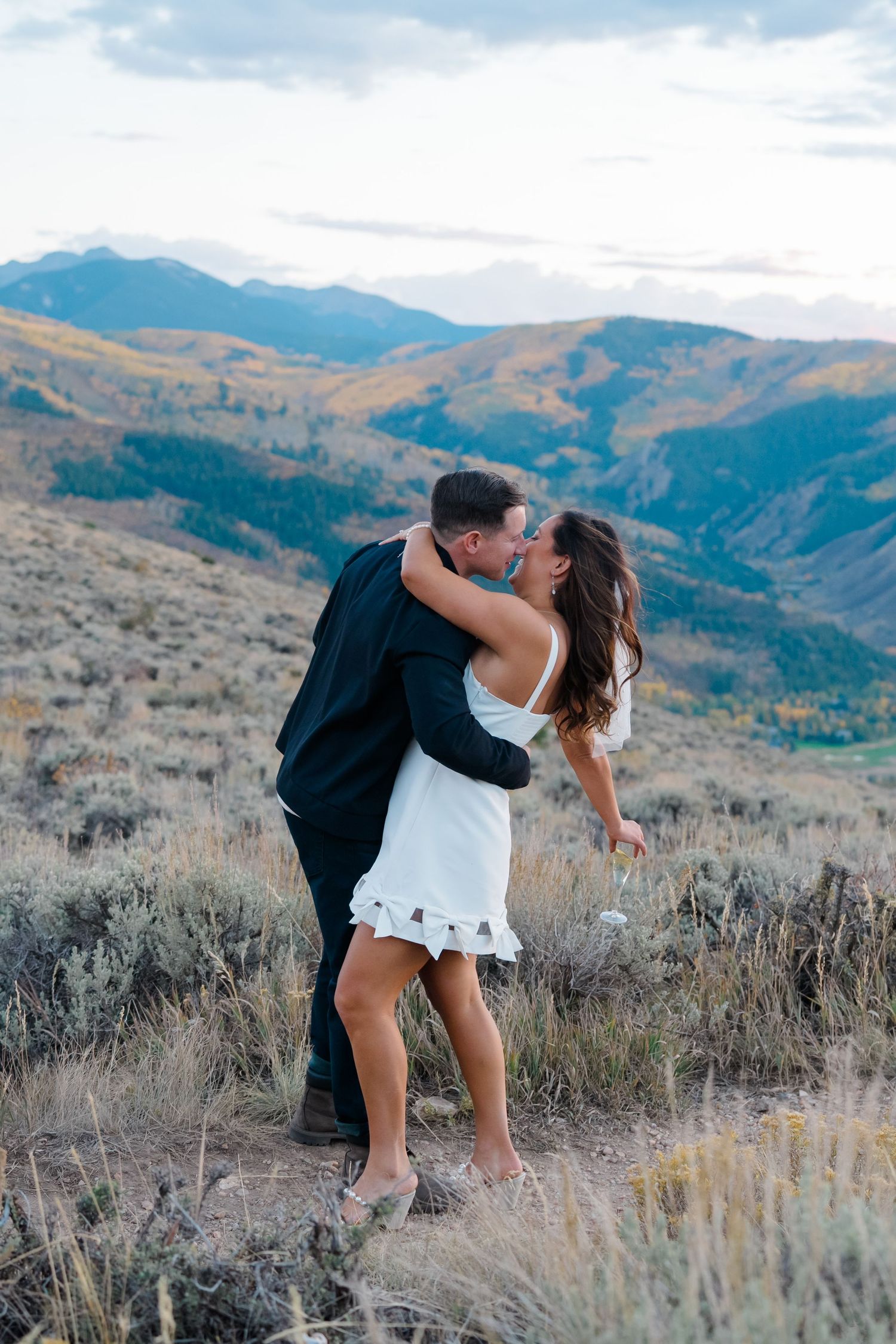 bride and groom eloping in vail colorado, they are kissing during vail proposal.