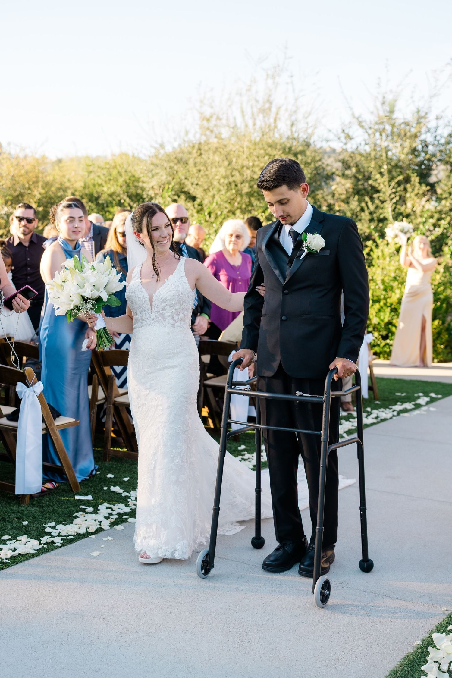 Amber and Neven Hart walking down the aisle together at their Canopy Grove wedding in Escondido, California, photographed by Sierra Sturt Ph