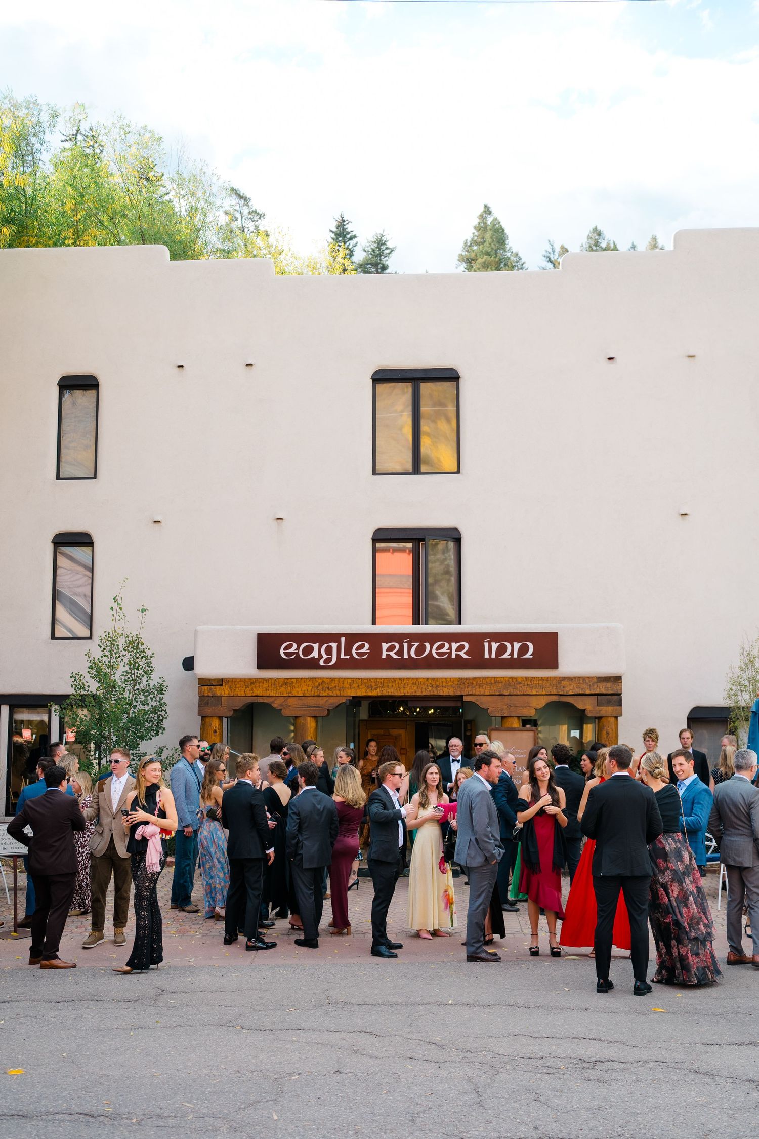 Wedding guests gathered outside the Eagle River Inn for an outdoor reception celebration.