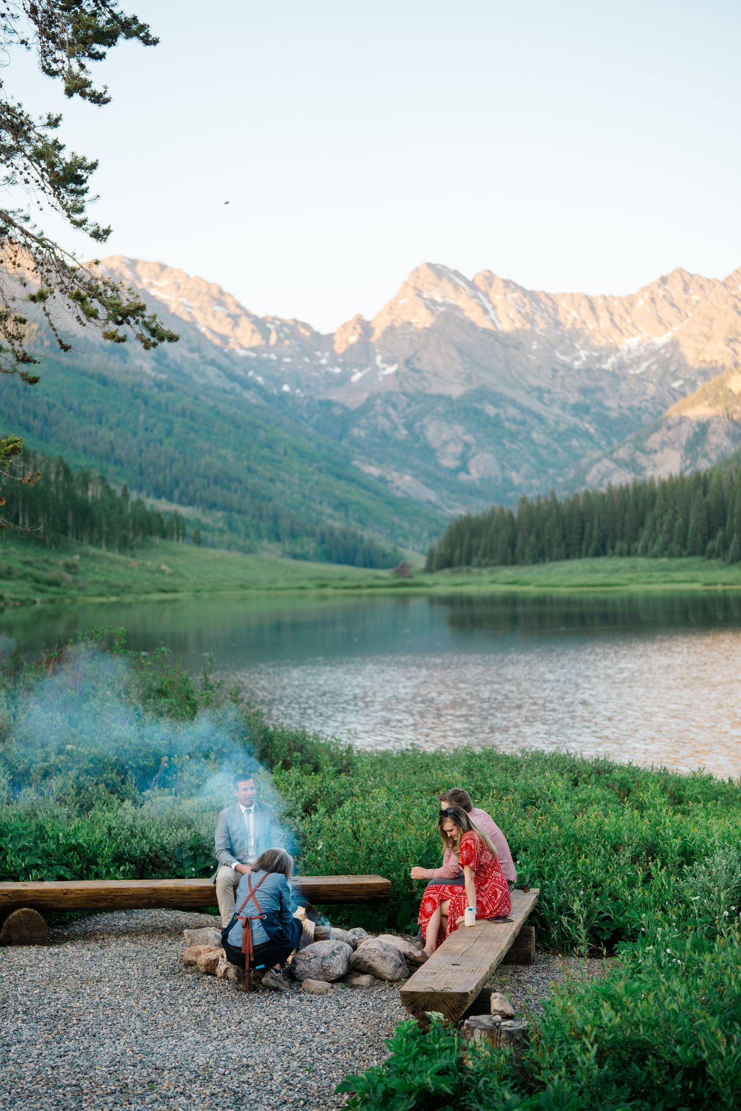Sunset view of Piney Lake with mountains reflecting in calm waters during golden hour at Piney River Ranch Wedding.